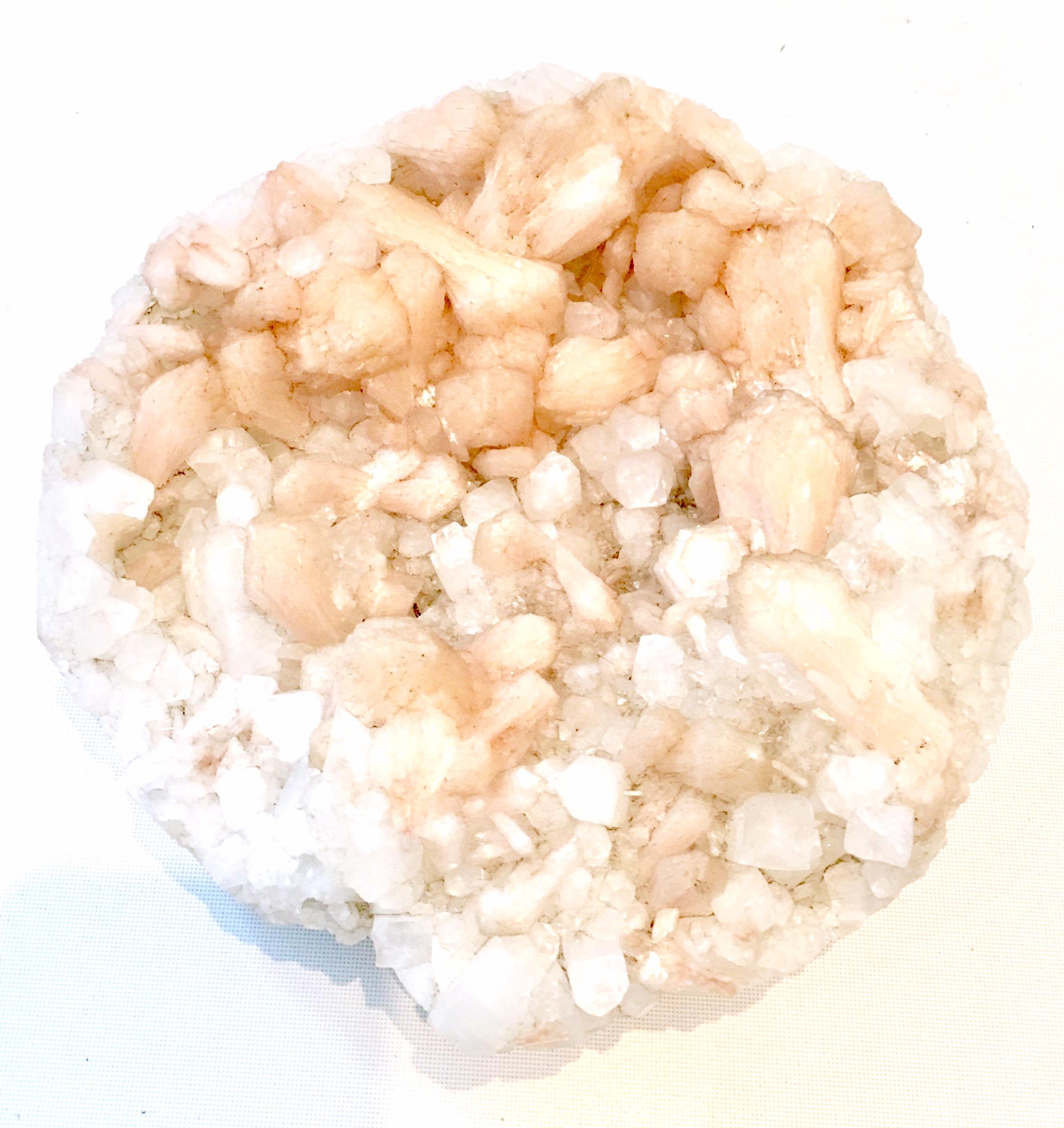 Organic, & Monumental Natural Geode Crystal Quartz Sculpture. Being of crystal clear and peach hue and weighing approximately 9.5 pounds this extraordinary piece of art will add calm and drama to any environment. 


  