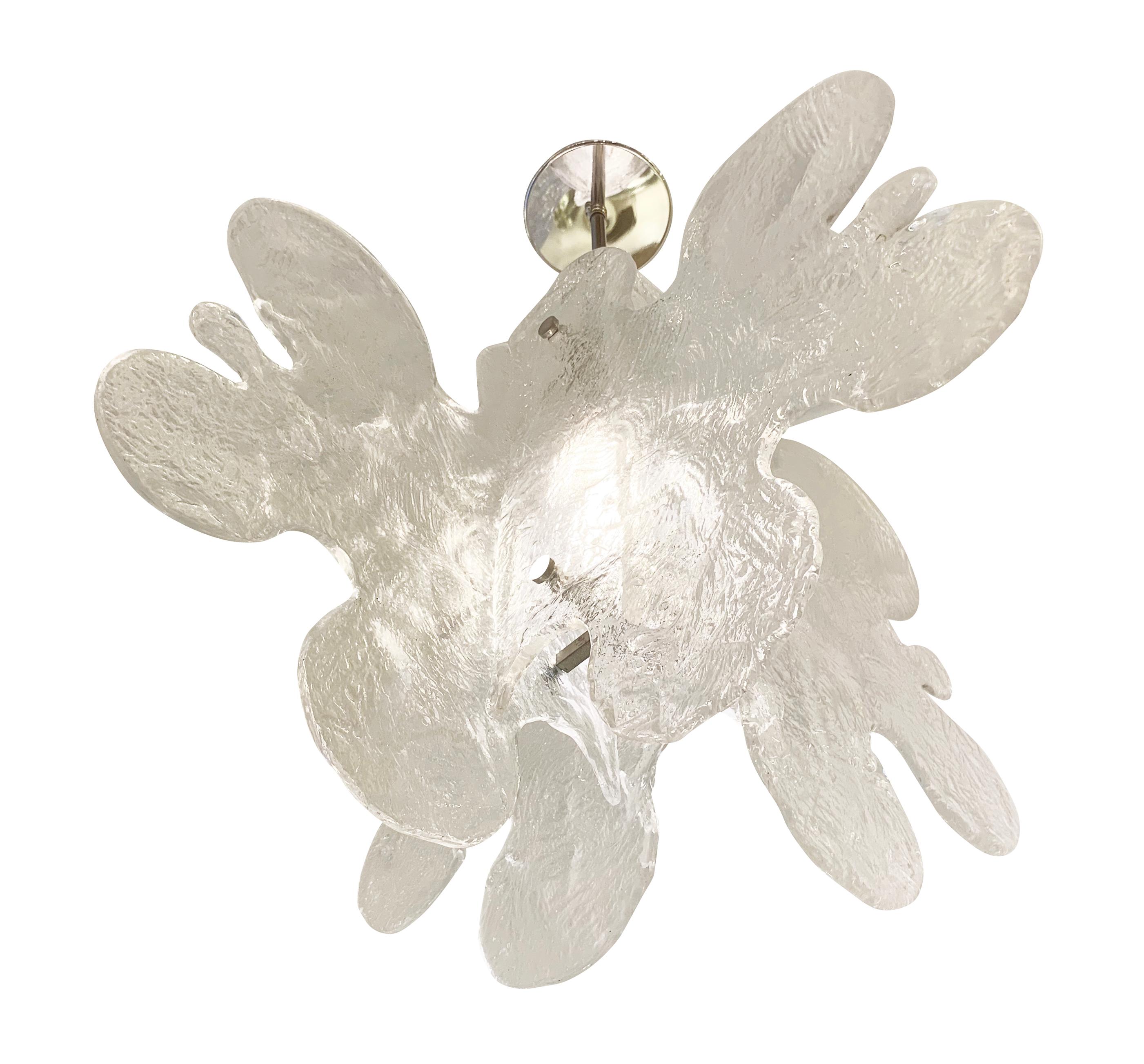 Murano glass pendant made by Mazzega in the 1960s featuring four organically shaped and textured glass slabs joined by a central frame. Nickel hardware holds one Edison socket. Stem length can be adjusted as needed.

Condition: Excellent vintage