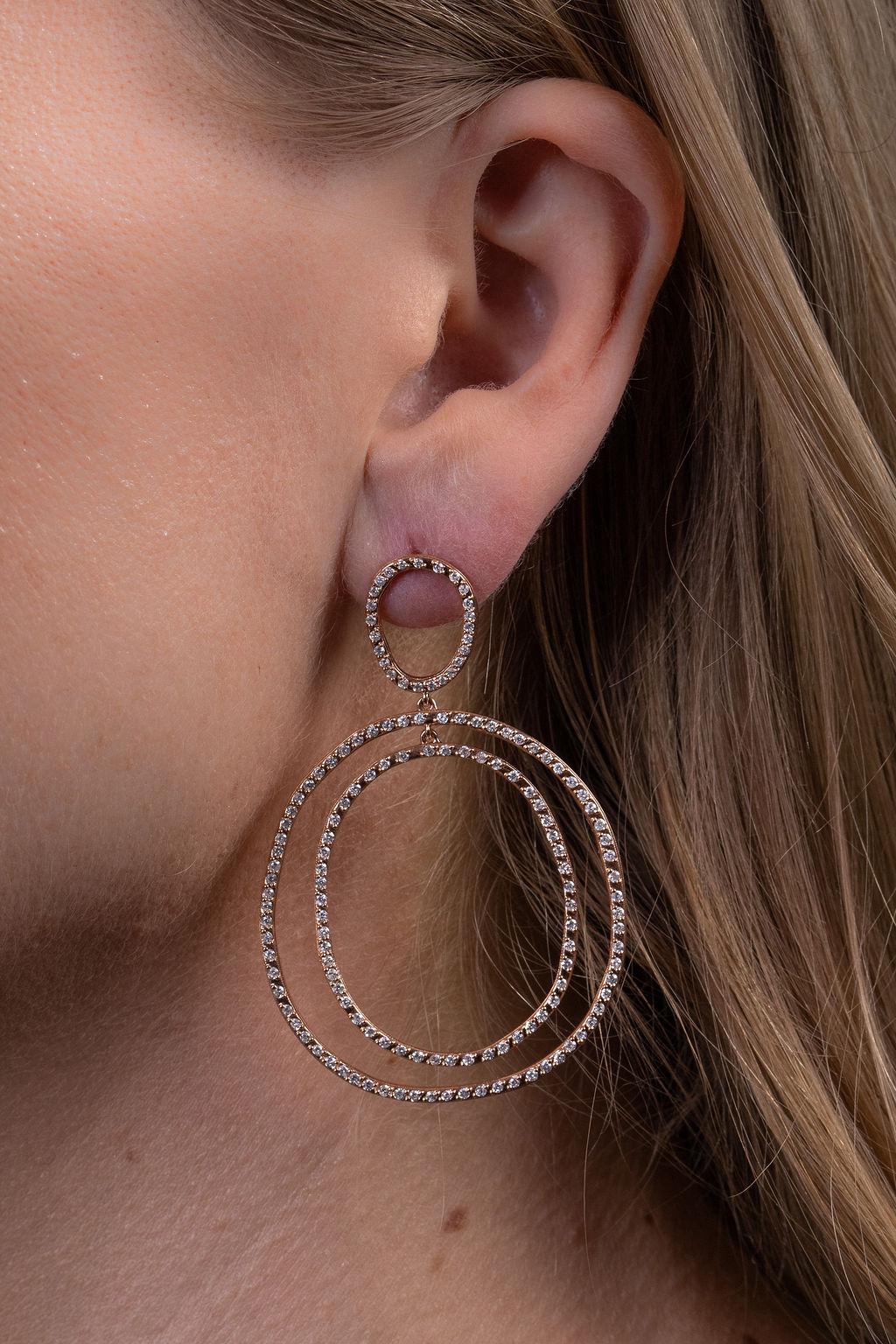These simple yet sophisticated double ovals are all about movement.  These versatile earrings transition beautifully from jeans to an evening dress.  Handcrafted in 18k rose gold, the earrings measure 3 1/2 inches and include approxiamately 2 carats