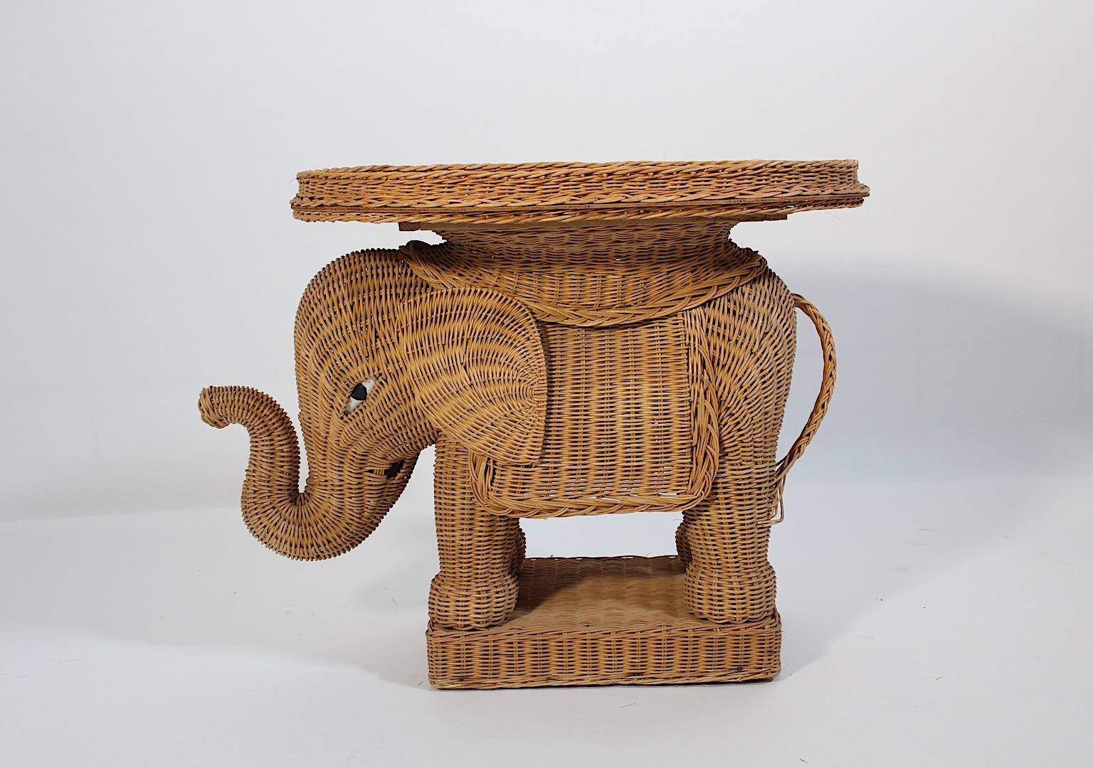 Organic Modern vintage side table or tray table or flower table elephant like from woven rattan and reinforced with plywood underneath.
A charming side table or tray table shaped like an elephant 1970s.
This elephant features a lovely and smiling