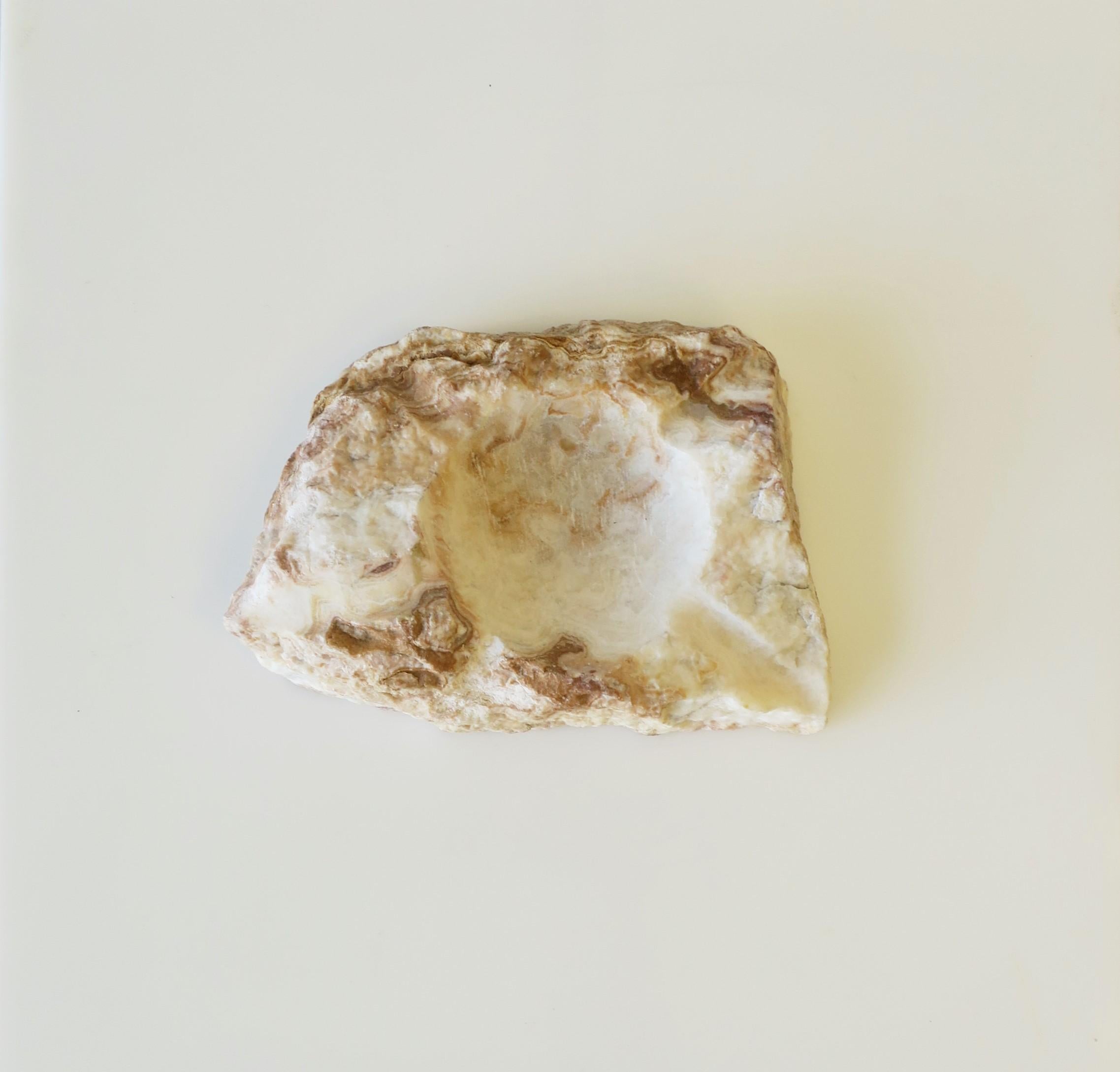 A natural organic raw stone catchall or ashtray in white and neutral colors. Dimensions: 4.5