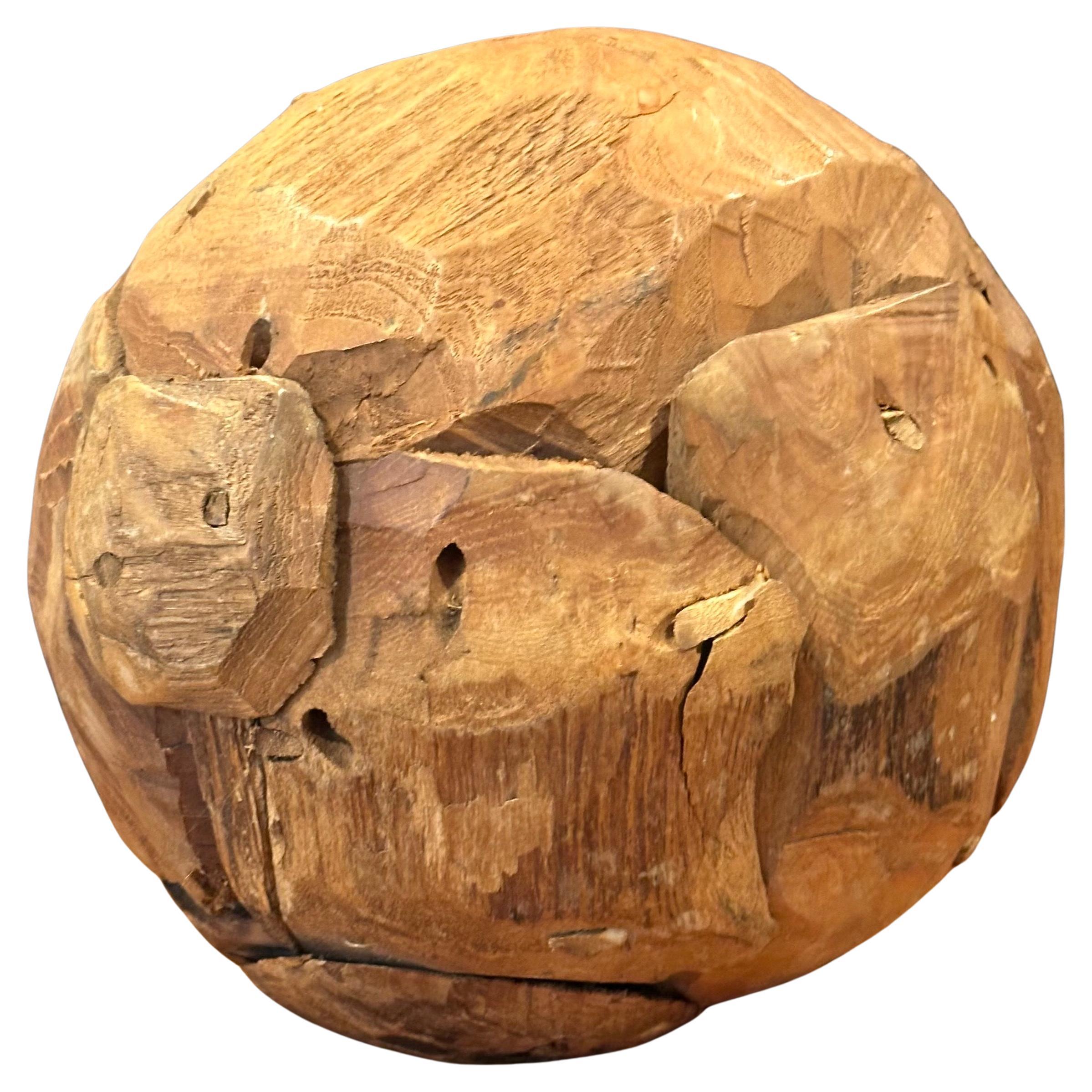 Super cool organic salvaged teak wood sphere sculpture, circa 1980s. The rustic sculpture is made of pieces of teak wood nailed together to form a sphere; it is in very good vintage condition and measures 10