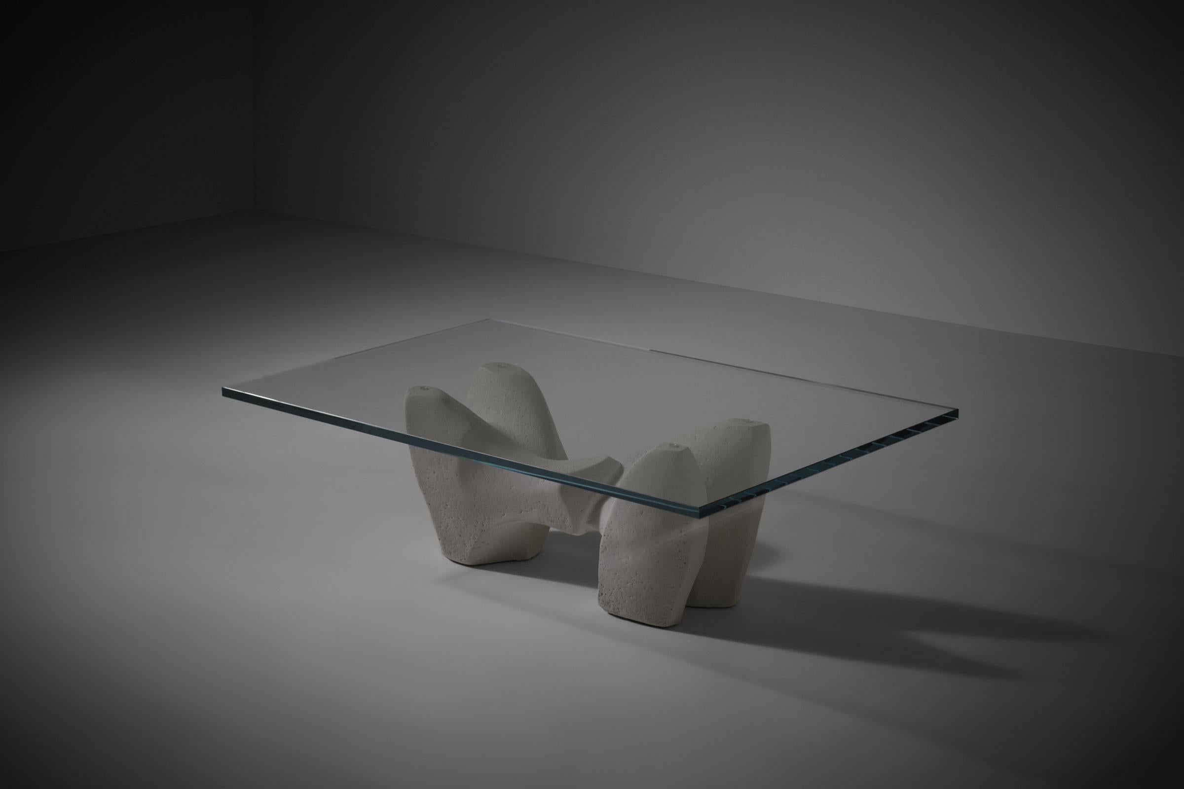 Organic sculptural concrete coffee table, Italy 1970s. The base is showing strong bulky organic shapes which flow over into each other. Sculpted out of solid concrete with a nice structured off white mineral plaster finish. Beautiful from every
