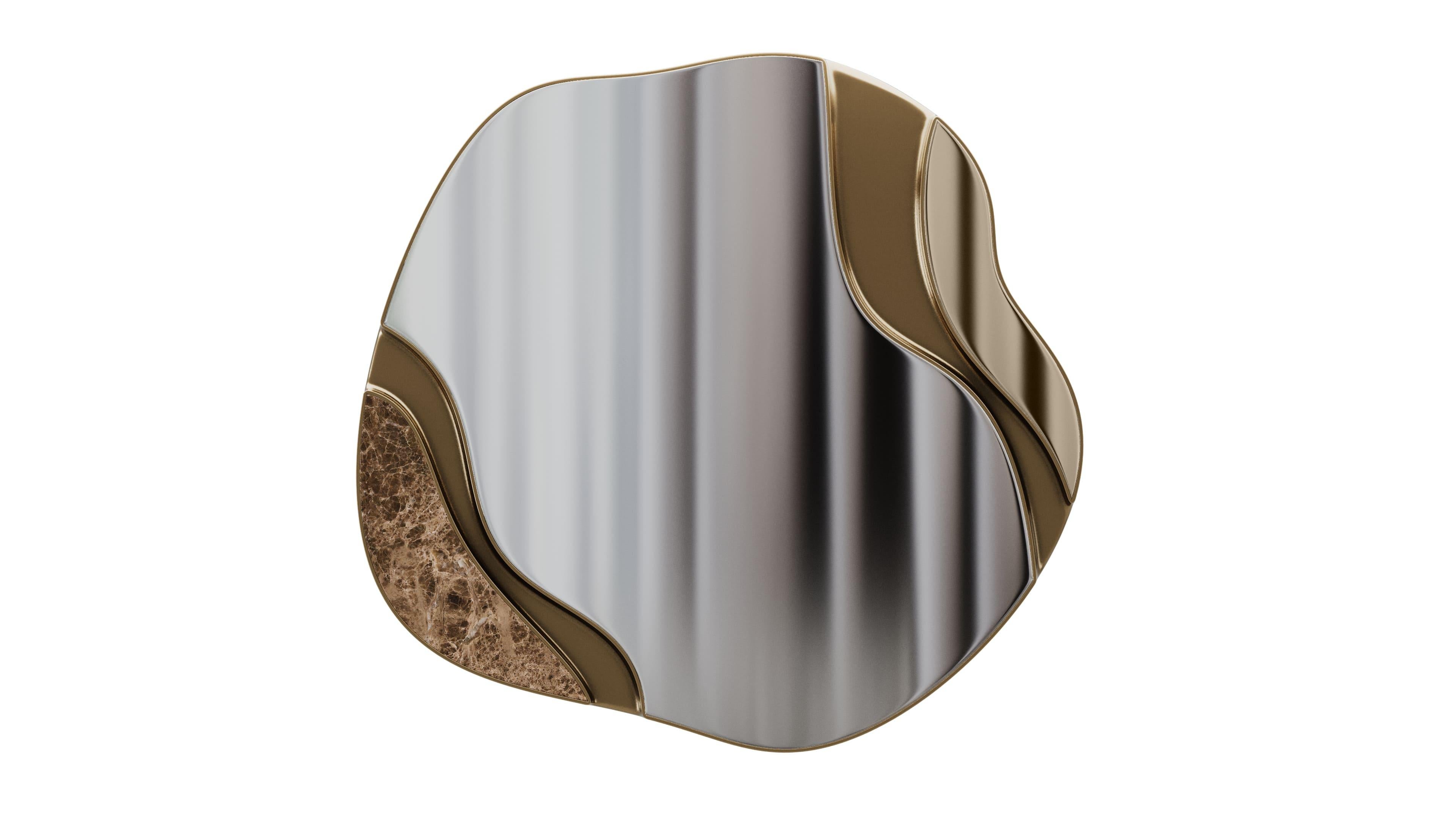 A striking mirror with organically shaped brass accents, creating a dynamic and fluid design. The frame is crafted from brushed brass, adding a modern and luxurious touch to the piece. The clear mirrored front reflects light beautifully, while