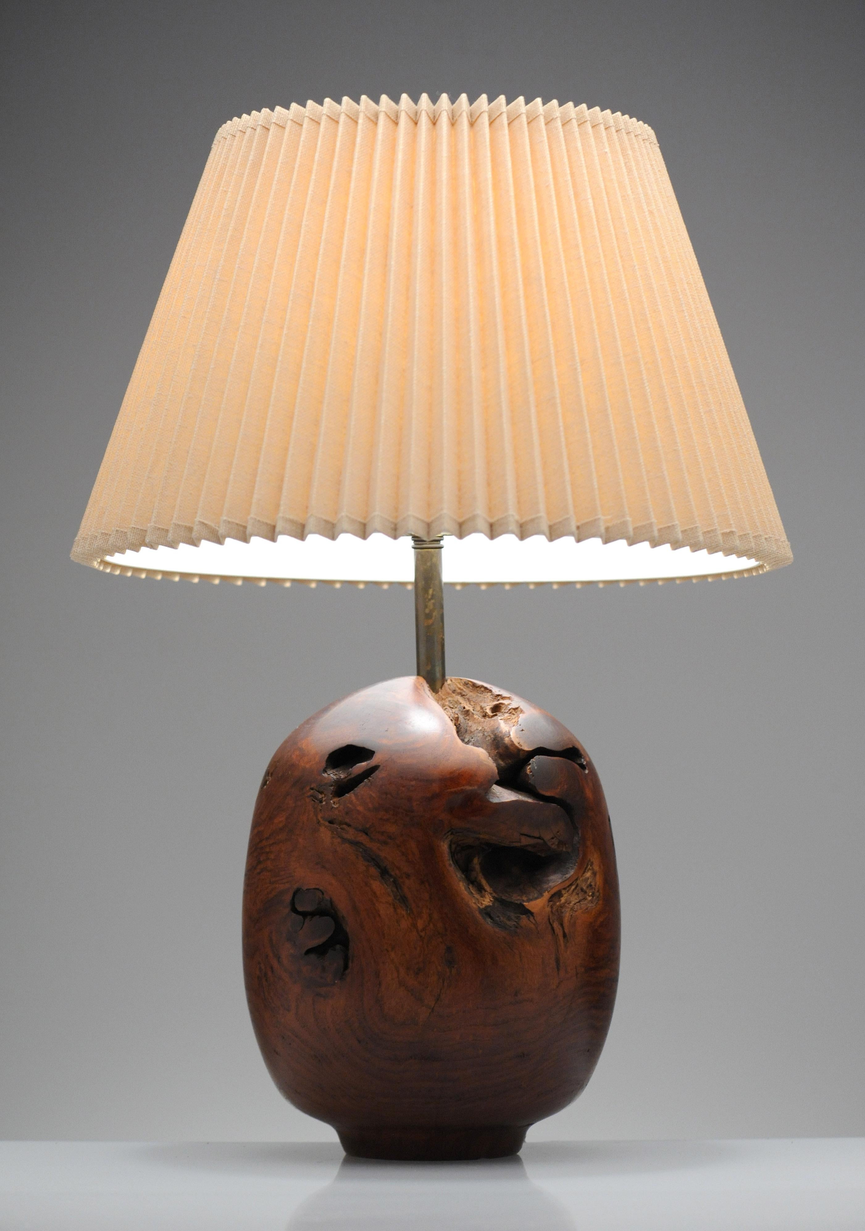 Beautiful turned wood lamp by Chris Eggers. Lamp is signed and dated 1986. 

Artist statement:
I primarily use tree stumps for my illuminated sculptures. Stumps are the heart of the tree, twisting in several directions with holes and knots. The