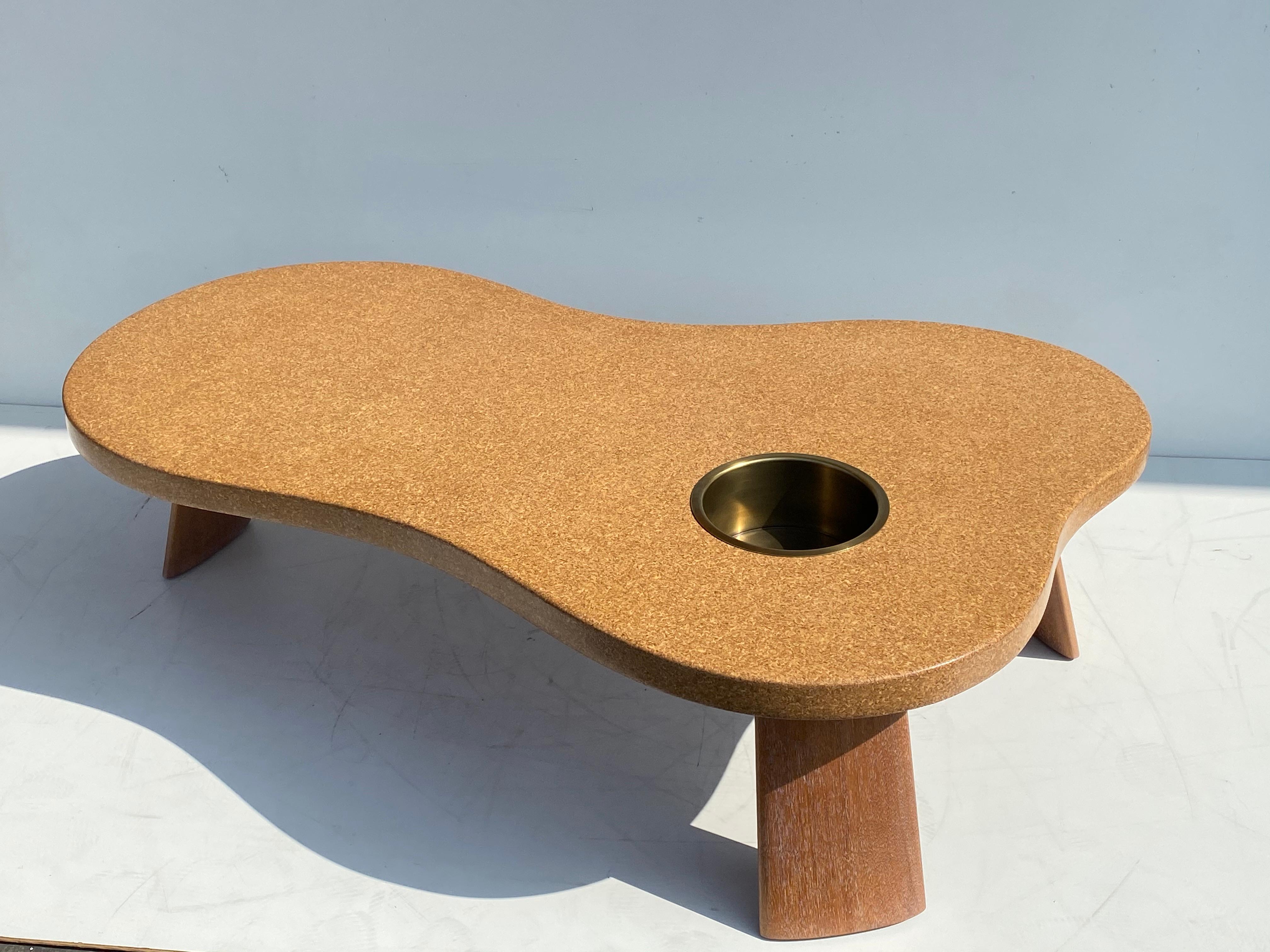 Organic shape cork and bleached Mahogany coffee table with removable planter or beverage cooler.
Brass planter / cooler is 8