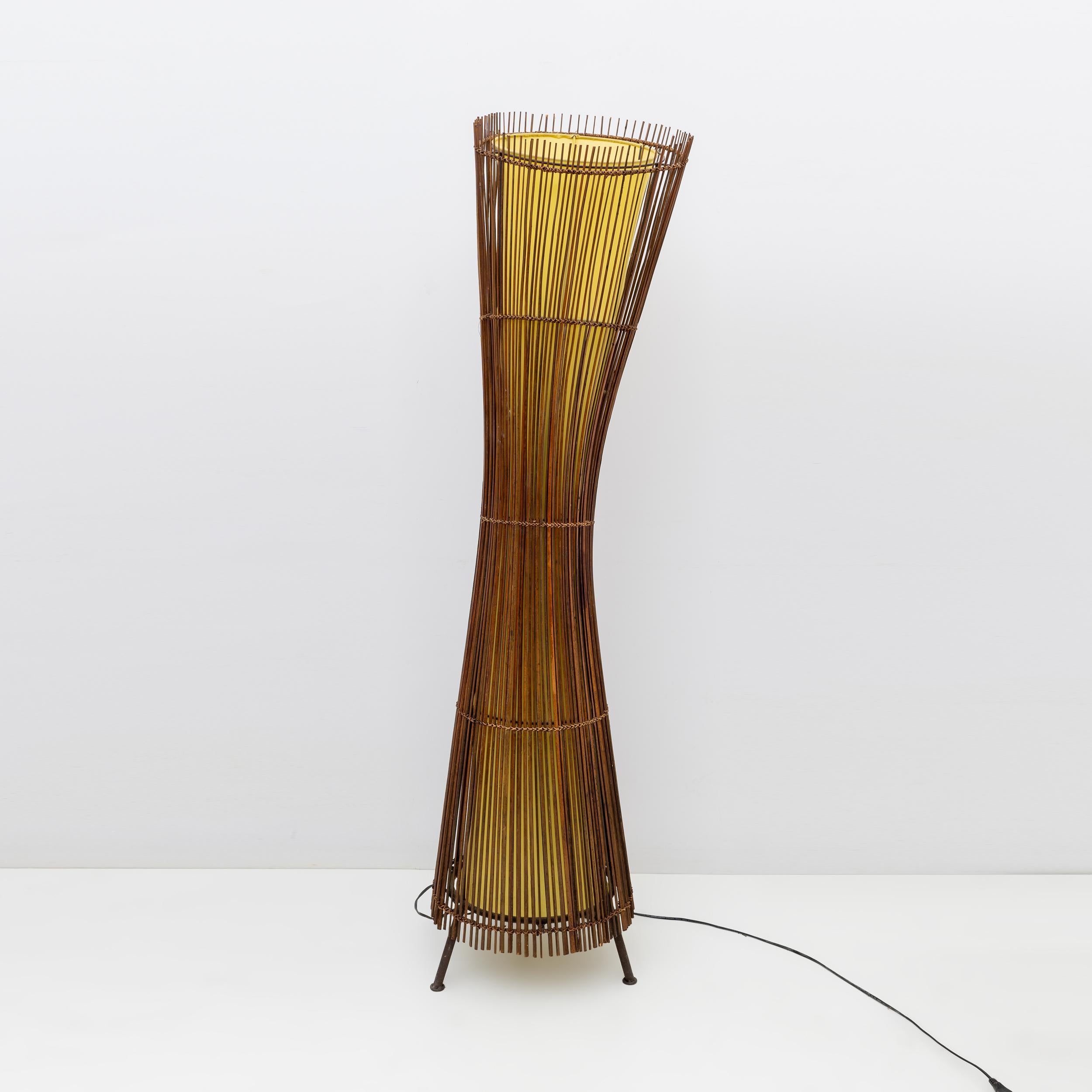 This sculptural floor lamp was made in France in the 1980s.
It has a beautiful organic shape made from iron and bamboo. The inner shade is made from yellow canvas

The lamp is equipped with three European standard E27 lamp sockets for Edison screw