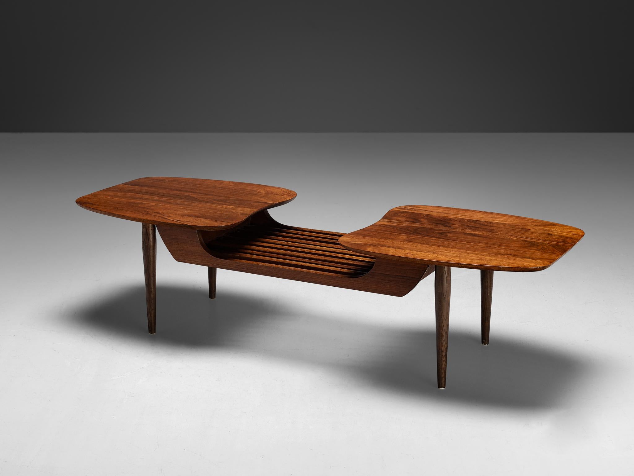 Coffee table, walnut, United States, 1960s

Interesting coffee table in walnut made in the United States. This design boasts two amorphous slab tabletops. Underneath the tops are numerous close slats, it forms a harmonious blend of functionality and