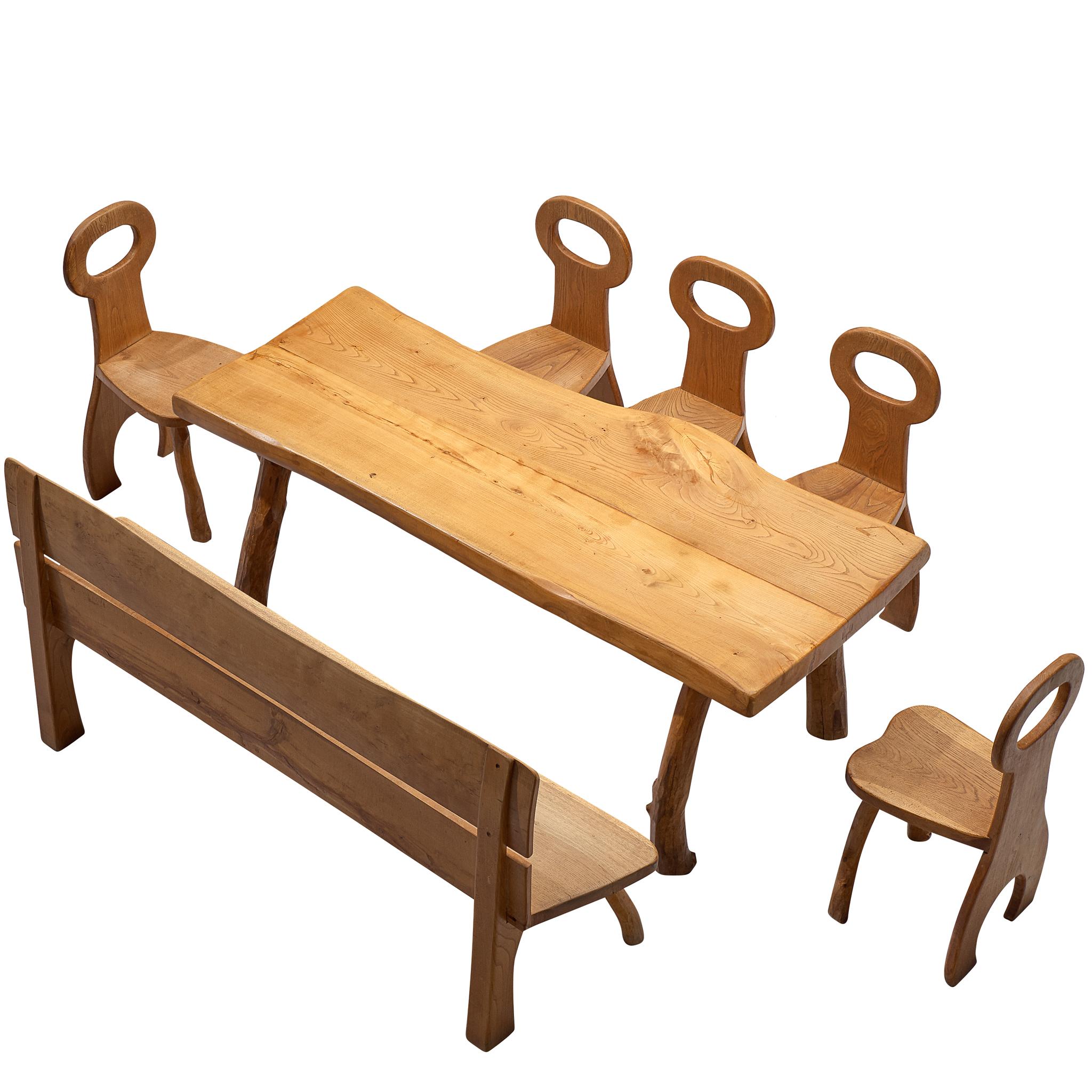 Dining room set, oak, France, 1960s.

Bulky oak wooden dining room set, consisting of a dining table, 5 chairs and one bench, that has robust design with organic elements. The pieces of furniture are all executed in solid oak that developed a