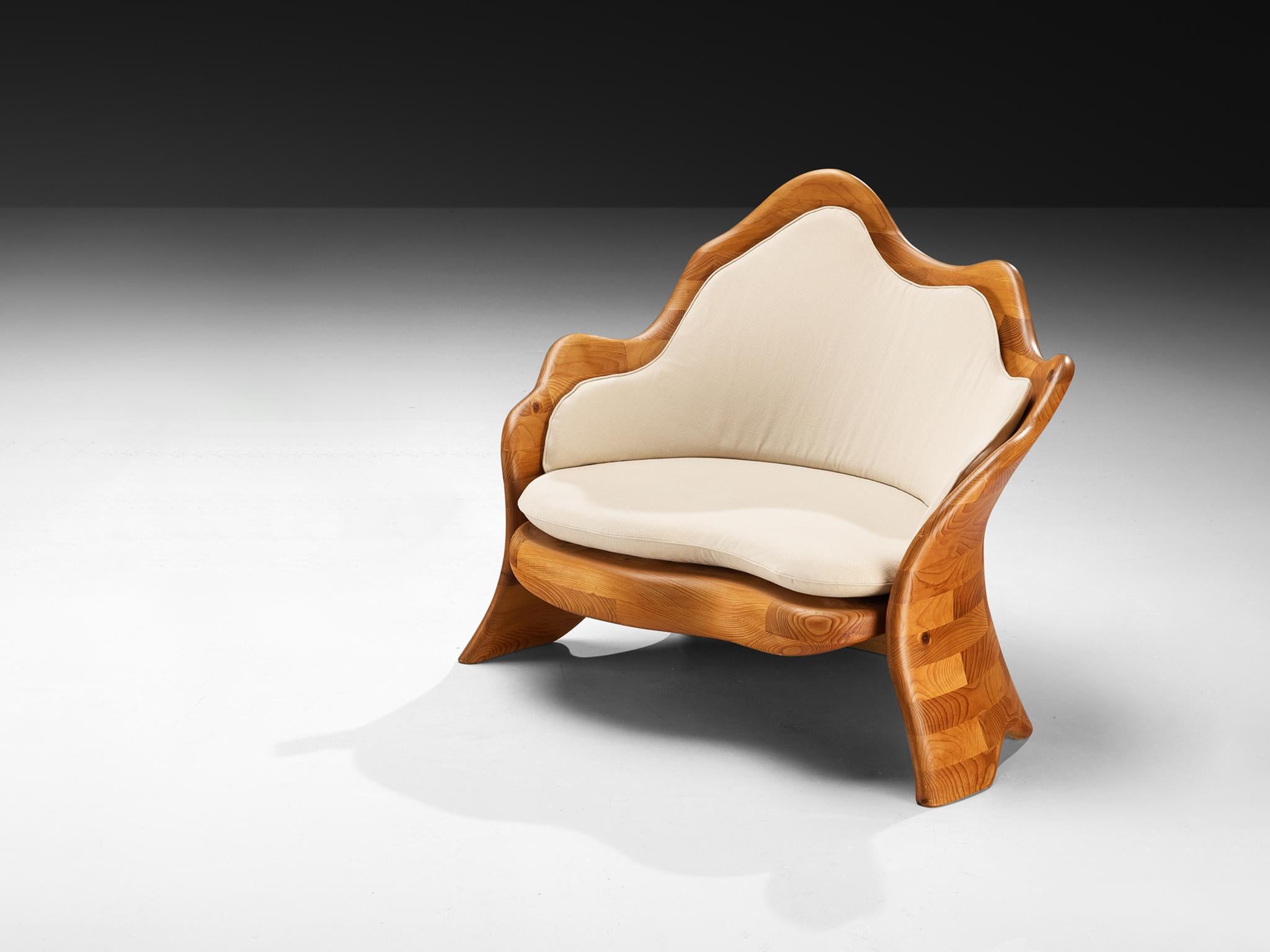 Organic shaped lounge chair, pine, fabric, Europe, 1970s

This sculptural lounge chair, crafted in Europe during the 1970s, embodies the organic spirit of its era through its fluid, curvilinear forms and natural materials. Executed in pinewood, the