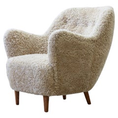 Organic sheepskin lounge chair in the style of Finn Juhl