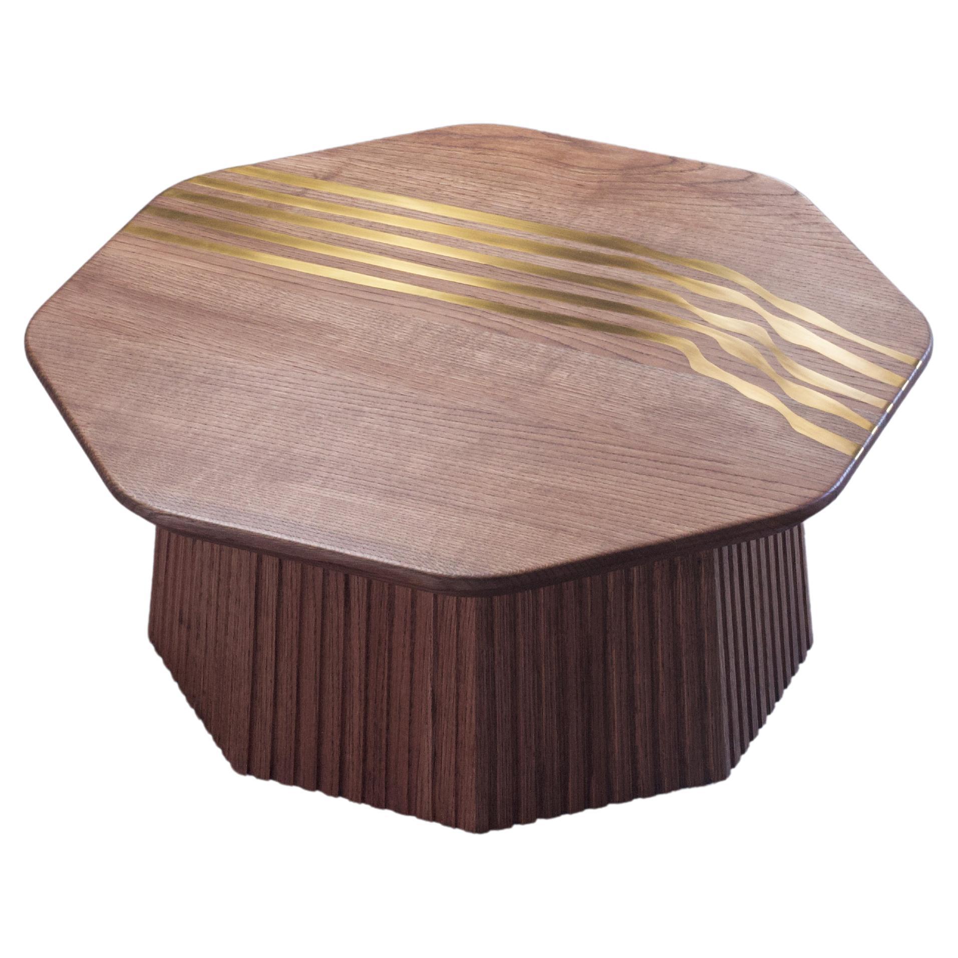 Inspired by the mesmerizing flow of molten lava, the Magma Coffee Table is an artistic fusion of form and function. Its meticulously crafted faceted base, sculpted from solid American Oak wood with intricate ribbed details, echoes the undulating
