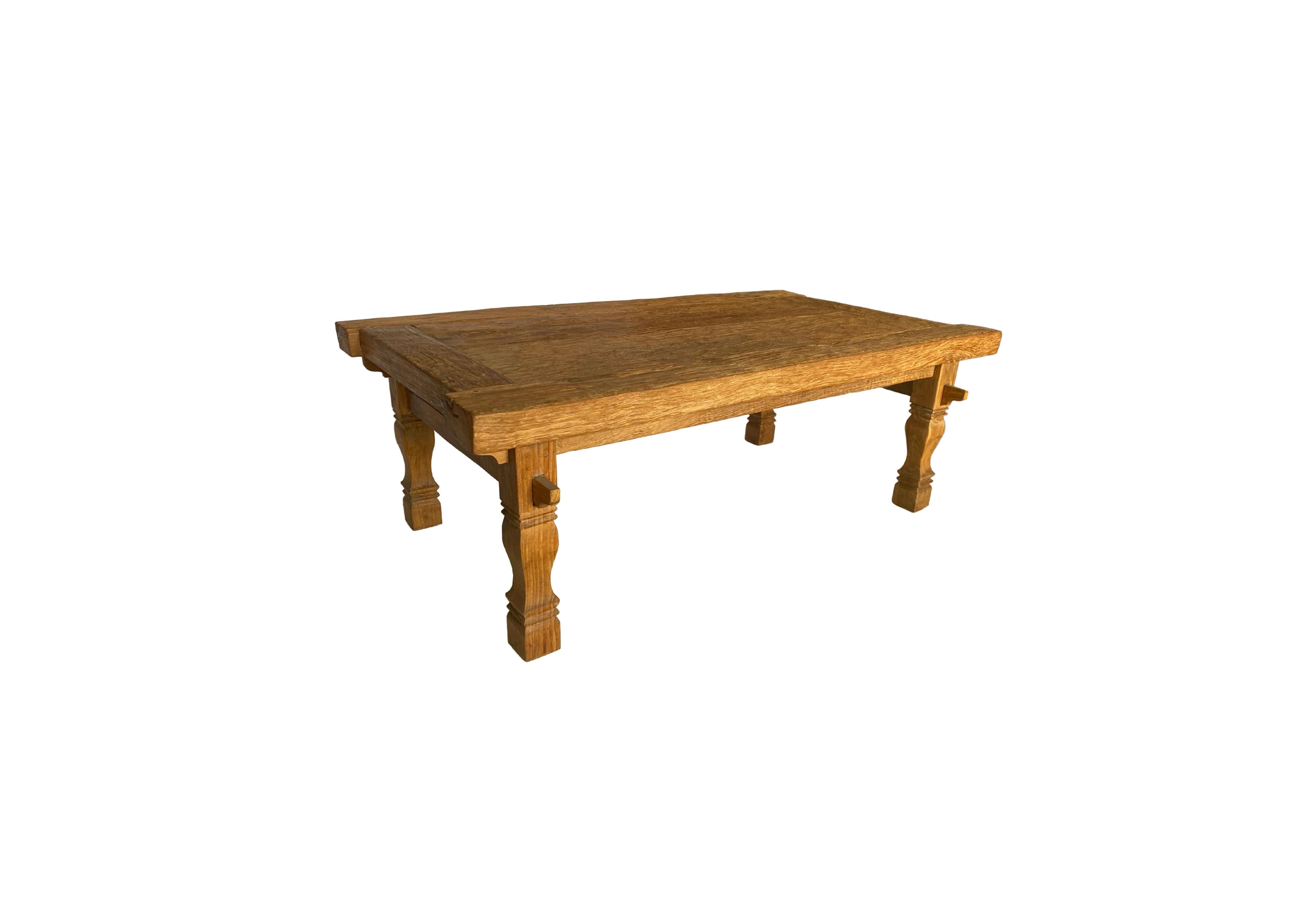 A skilfully crafted teak wood table. This table was crafted by local artisans using a wood joinery technique without the use of nails. The table is wonderfully proportioned with legs that feature carved detailing. The teak wood patterning and