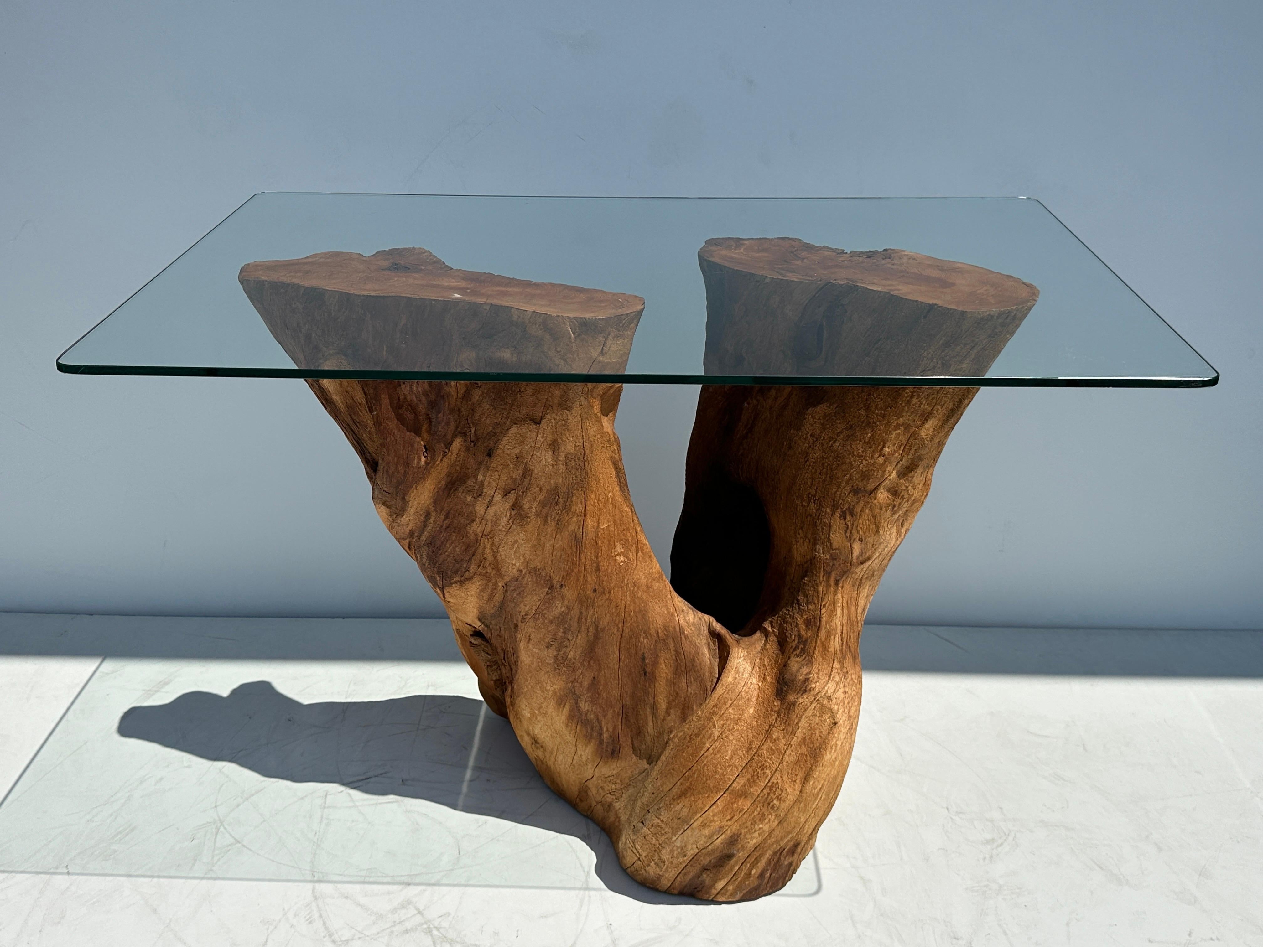 Organic natural shaped cypress tree trunk console table. Glass top shown is 26” deep by 42” wide.
Trunk base is 19” deep, 35” wide, 29.5” high.
It will hold larger and thicker glass top.