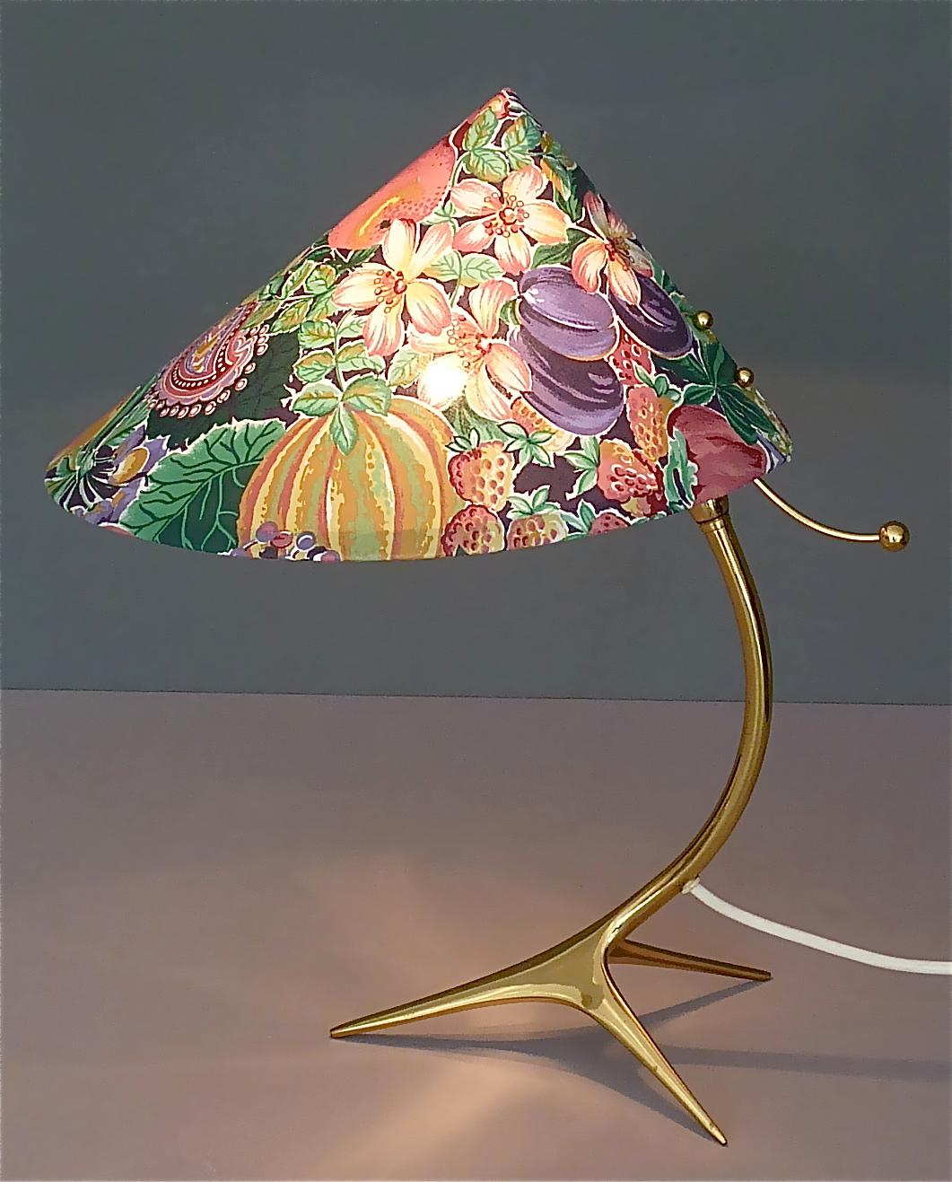 Amazing midcentury tripod brass table lamp in the style of Josef Frank, Kalmar or Nikoll, Austria or Germany, 1950s. The organic design brass tripod lamp base comes with its original but new refurbished fabric shade with a colorful fruits and