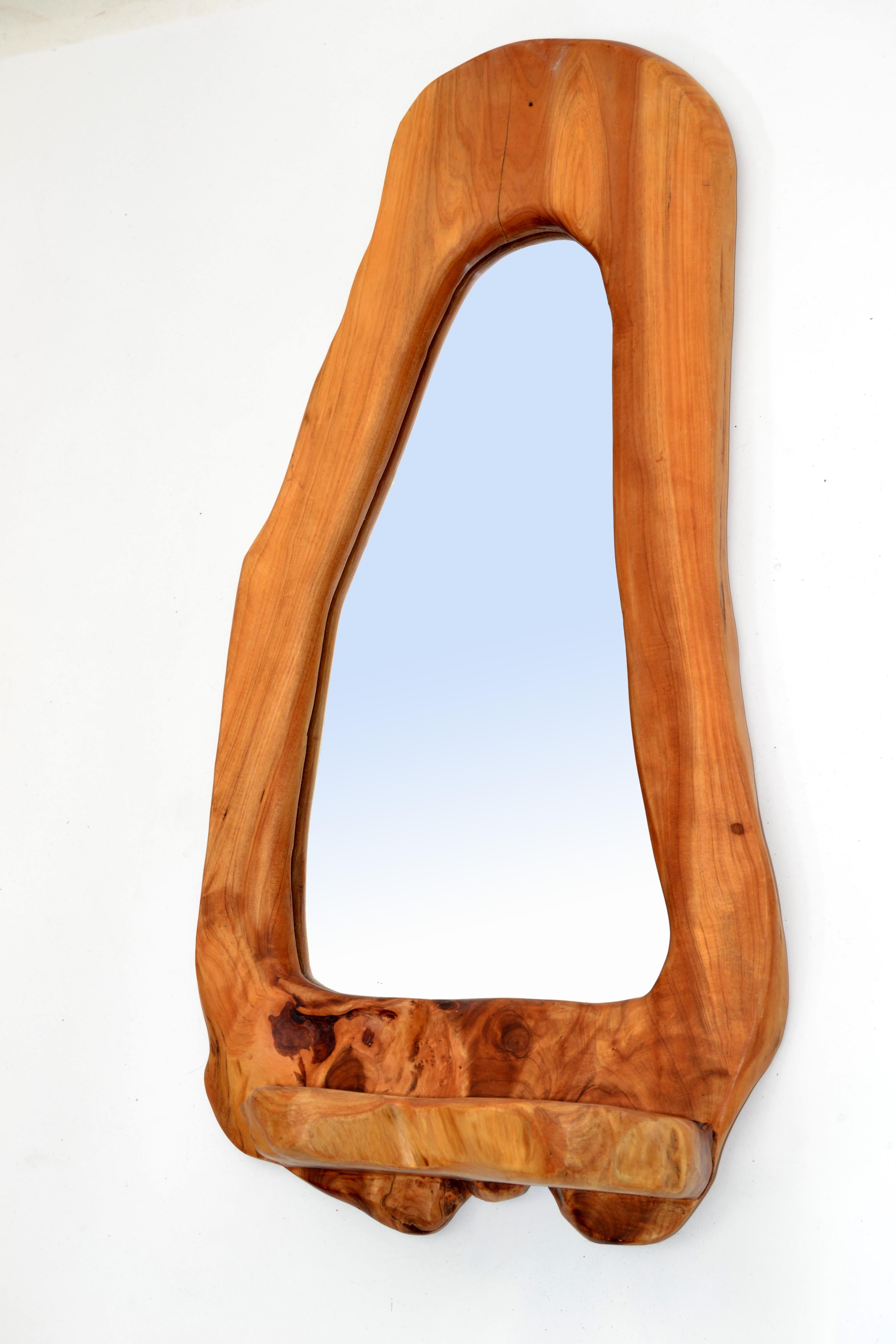 Mid-Century Modern American Organic Burl Wood rectangular wall mirror from the 1970s.
Amazingly handcrafted burl wood grain bordered the central mirror.
Mirror size: 7.5 inches x 15 inches.