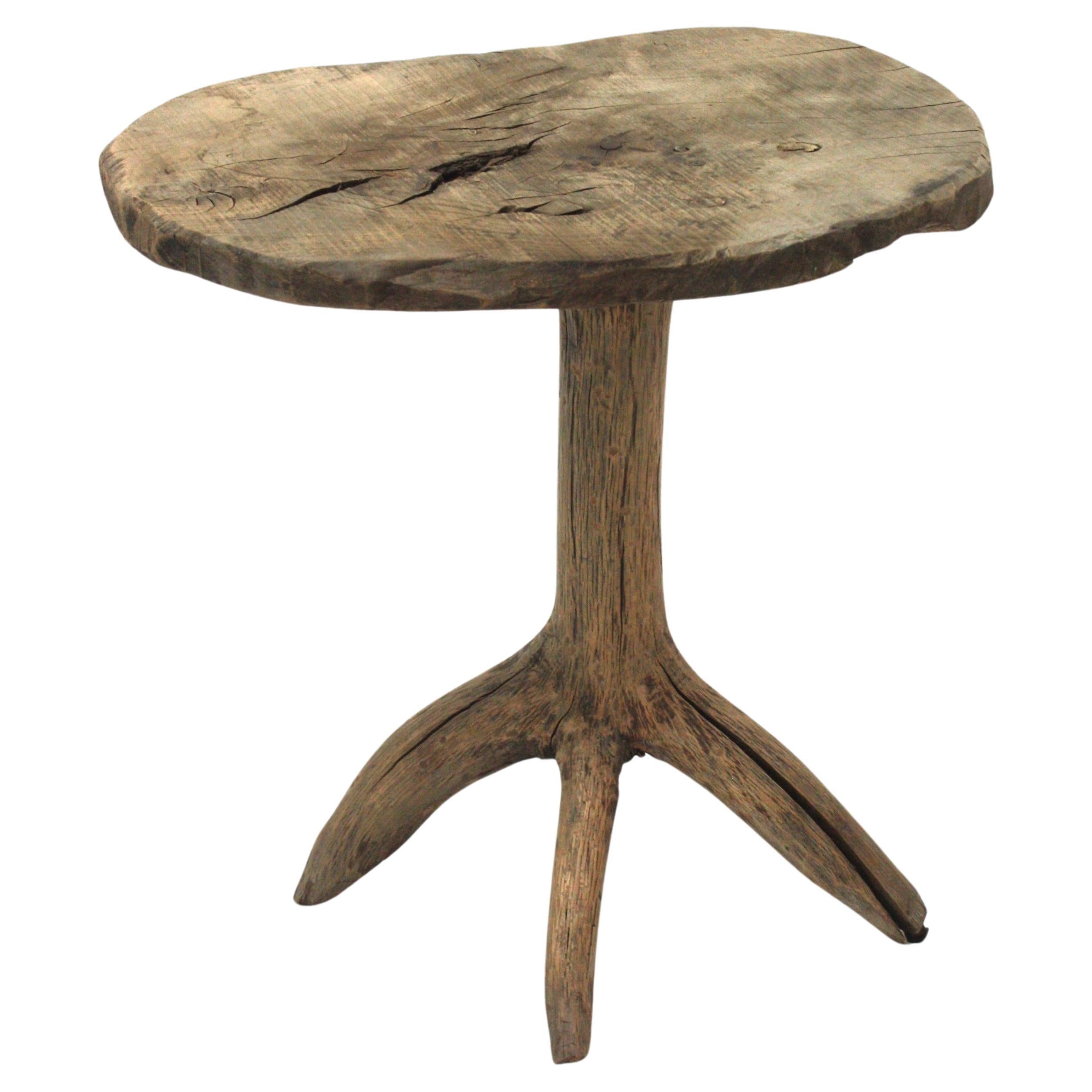 Spanish Side Table in Natural Wood
Spanish Brutalist Wabi Sabi Rustic Tripod Side Table, 1950s
Eye-catching wooden rustic tripod four footed side table with organic design and natural finish.
This sculptural end or side table has a primitive
