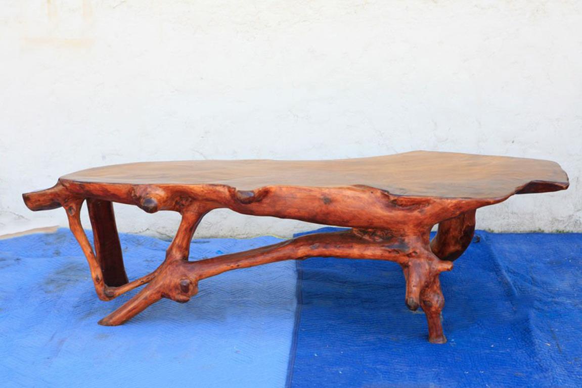 A freeform organic table in solid walnut in the style of Nakashima.