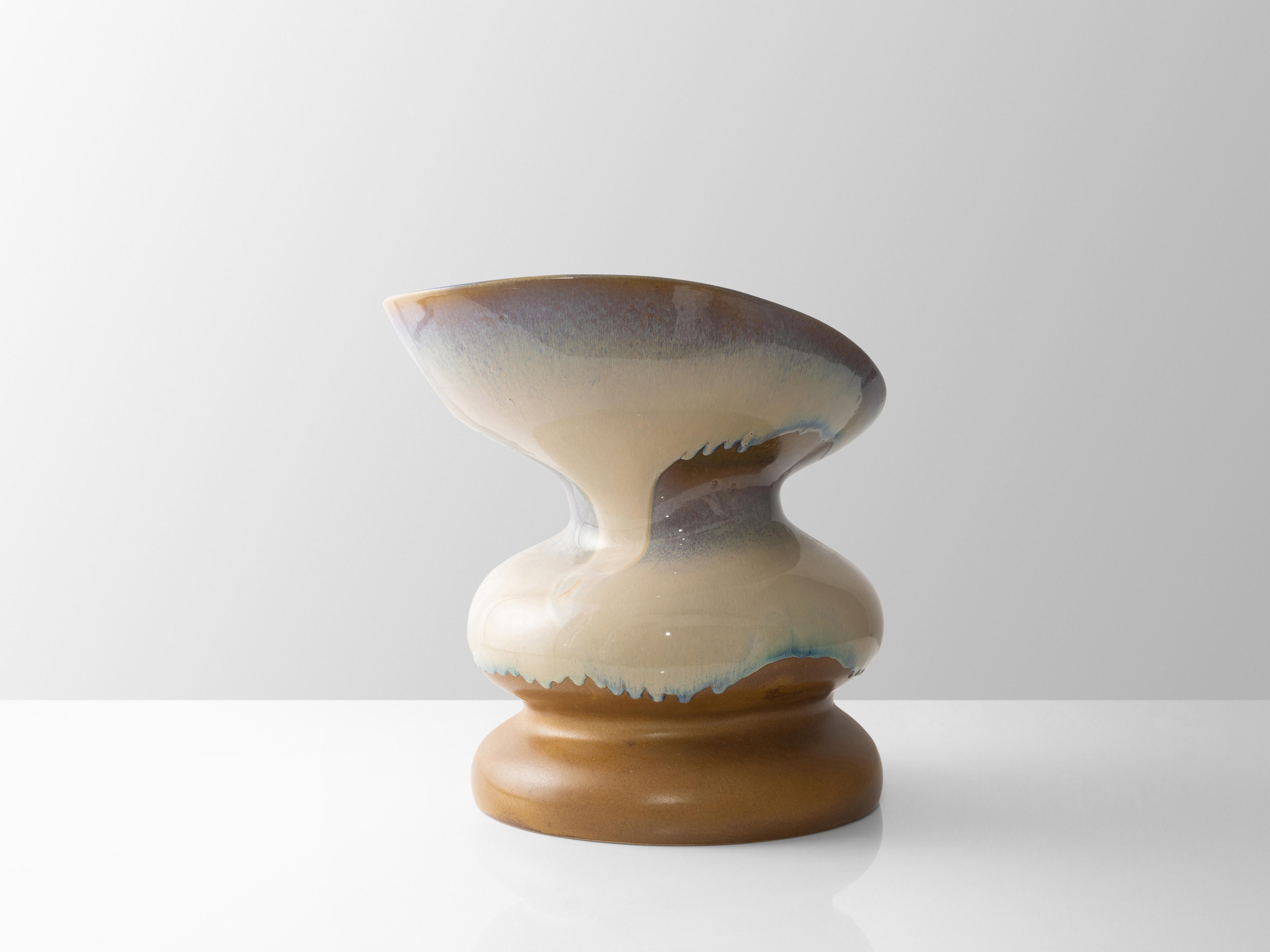 This ceramic crafted Chair displays experimental glaze work dripping and following its unique form, each piece glazing will be unique and different from each other. Its form has been digitally designed by our studio to ressemble a curved and