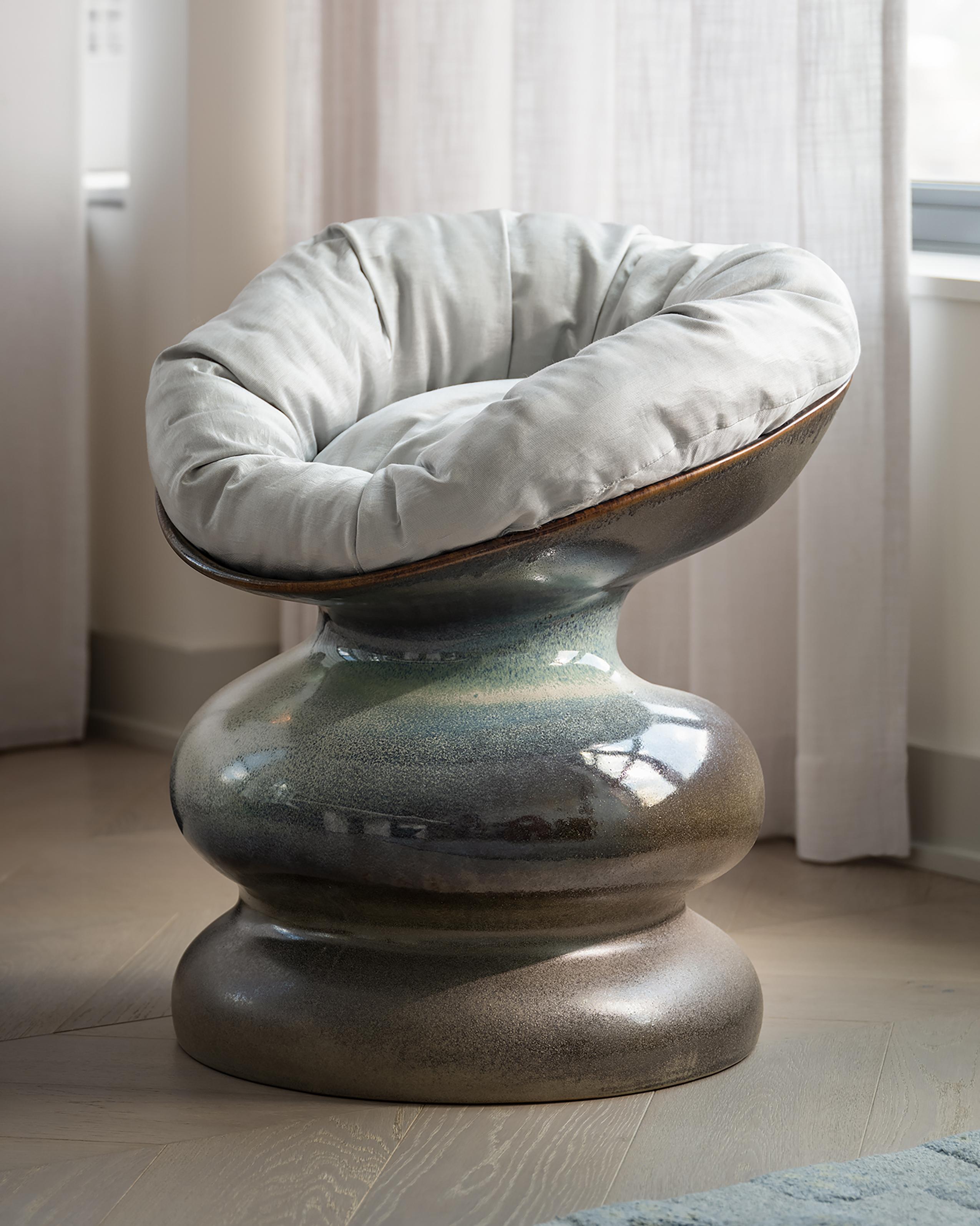 This ceramic crafted Chair displays experimental glaze work dripping and following its unique form, each piece glazing will be unique and different from each other. Its form has been digitally designed by our studio to ressemble a curved and