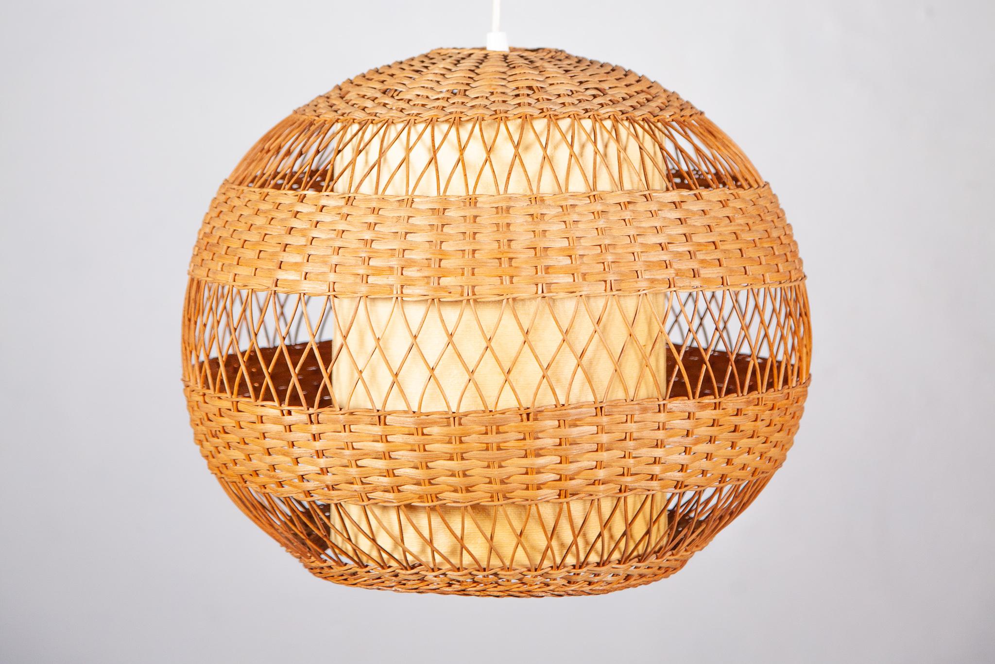 Natural organic woven wicker and bamboo large globe pendant hanging light 1950s.The beautiful suspension lamp features a bamboo and wicker wire. The pendant lamp will be a nice addition hanging over a dining table, kitchen's table or any room with
