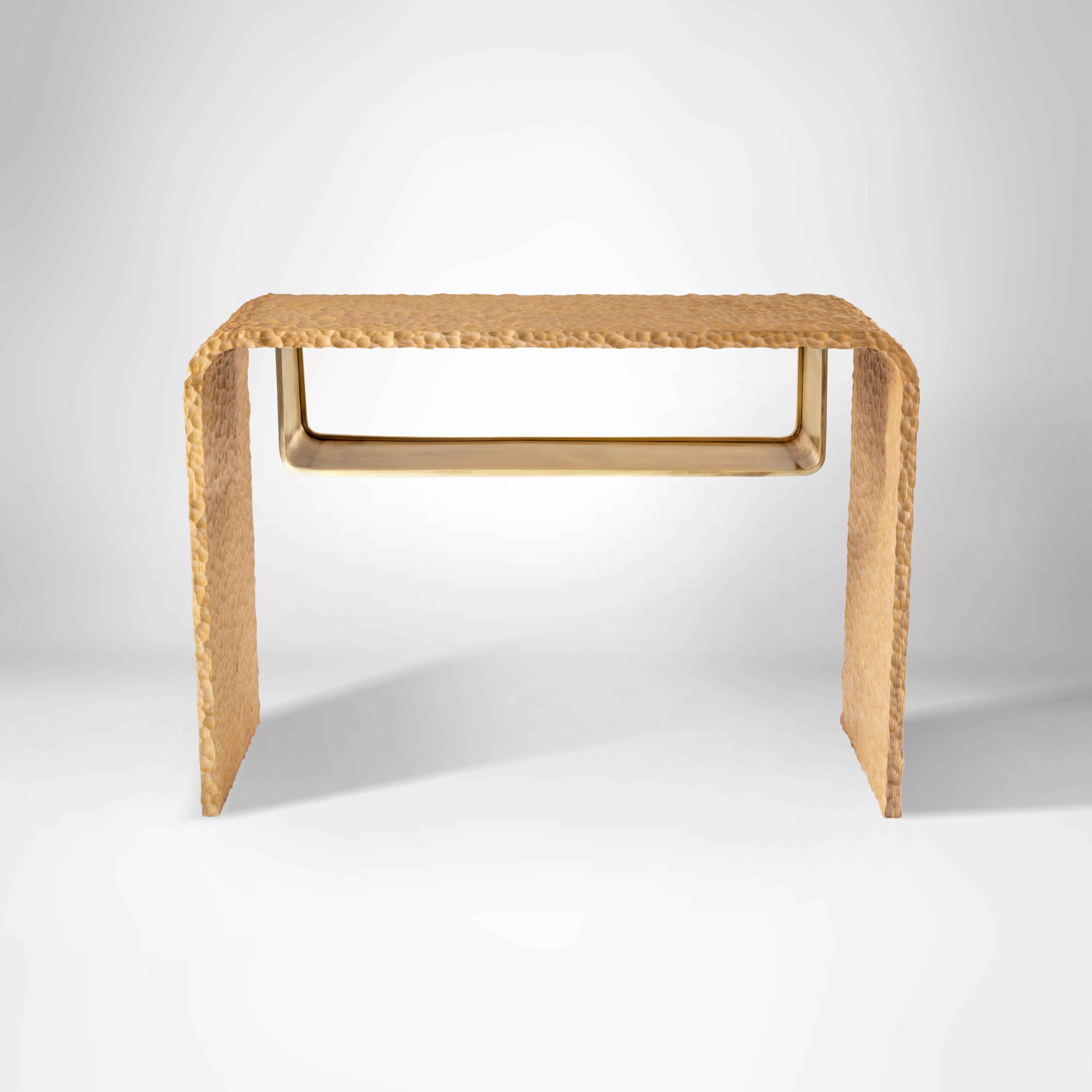 Organically Hand-Carved Massive Oak Wood Console with Hanging Brass Shelf.
There’s beauty in matching the unexpected. With our Opposites Attract console we contrast smooth shiny brass against rocky hand-crafted Oak wood to create this magical