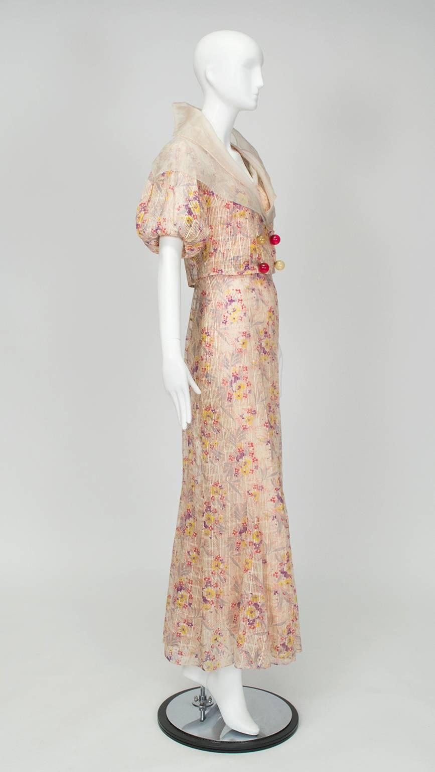 Gatsbyesque in silhouette, this gown and jacket are so lightweight they would practically appear holographic were it not for their floral pattern. The secret is the unusual fabric, which consists of alternating 1/8” ribbons of printed organza and