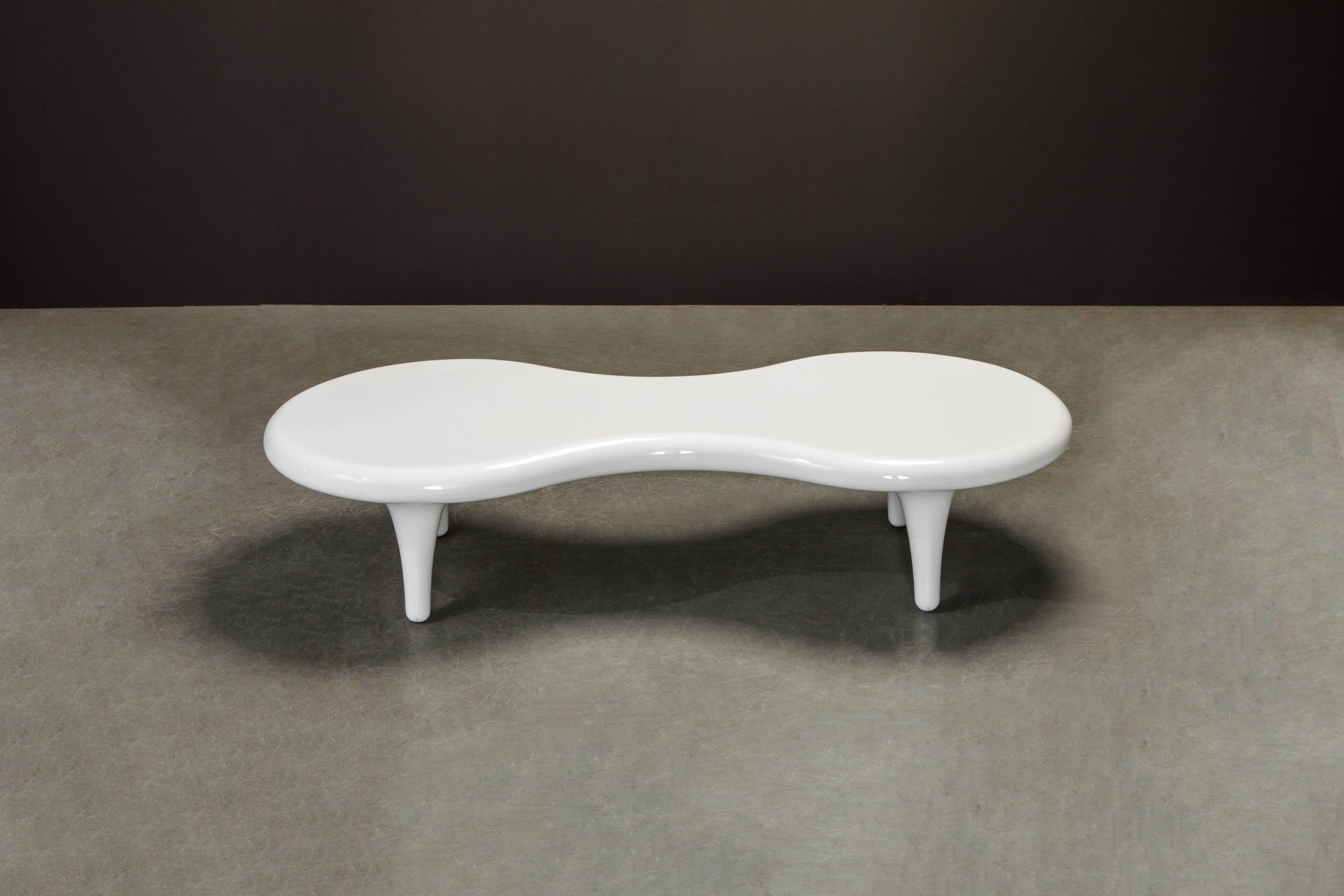 This beautiful Organic Modern 'Orgone' cocktail table by designer Marc Newson was created for Cappellini, Italy. Elevated above four legs, the 'Orgone' table is made of fiberglass with a poplar fiberglass insert. The silhouette is evocative of a