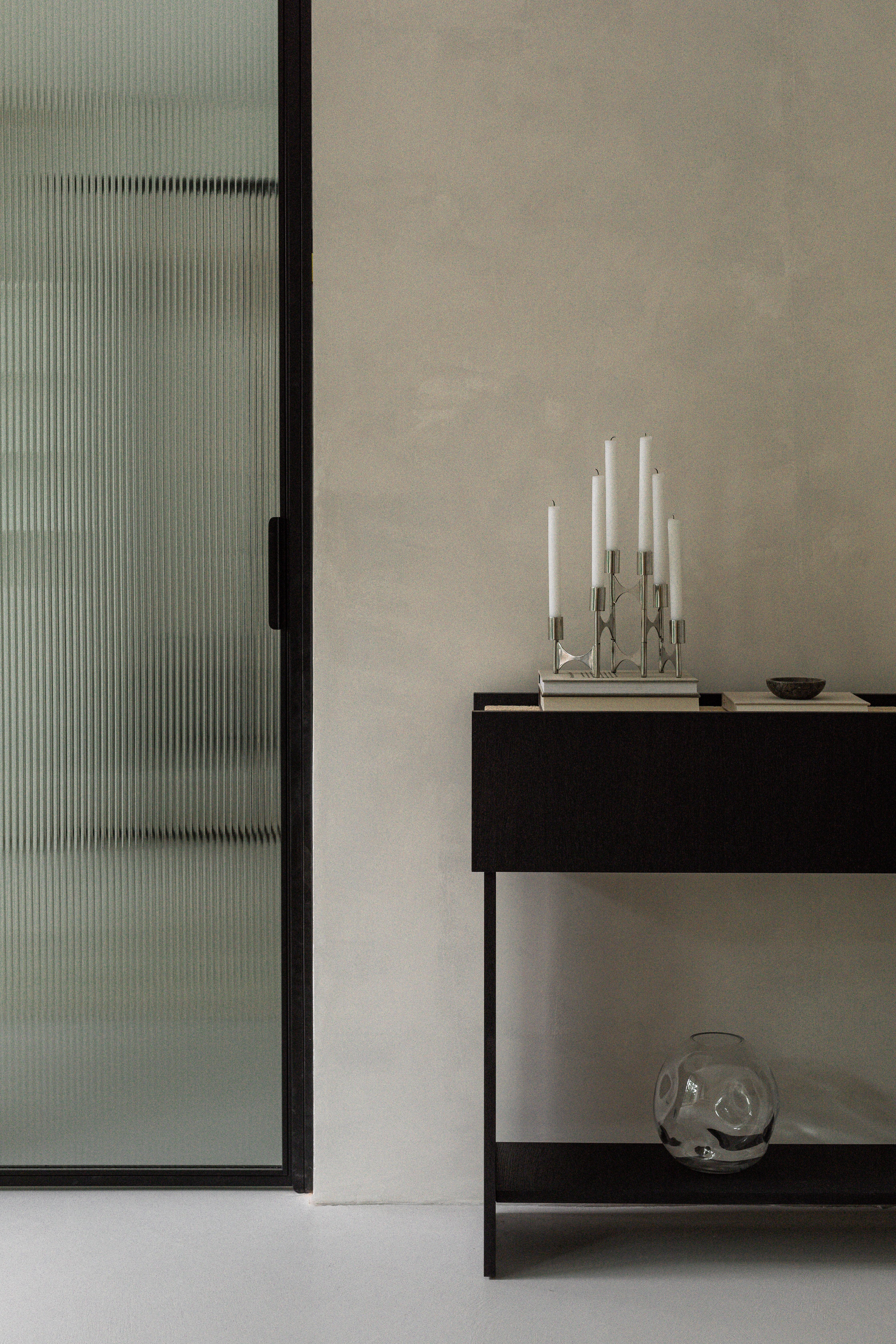 Oria Console Table by Un’common
Designed by Małgorzata Korycka.
Dimensions: D 30 x W 90 x H 33 cm.
Materials: Travertine and oak.

The Oria console from the LINEE series is a piece of furniture with a simple form with a characteristic plinth around