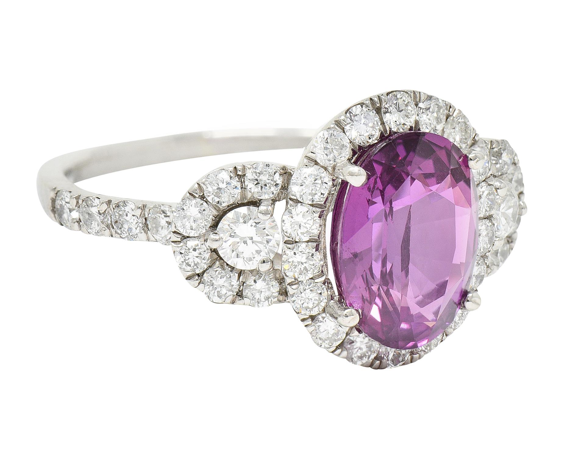 Featuring an oval mixed cut sapphire weighing approximately 2.20 carats

Eye clean with strong violetish pink color

Flanked by two round brilliant cut diamonds weighing collectively 0.15 carat

All three stones are encompassed by round brilliant