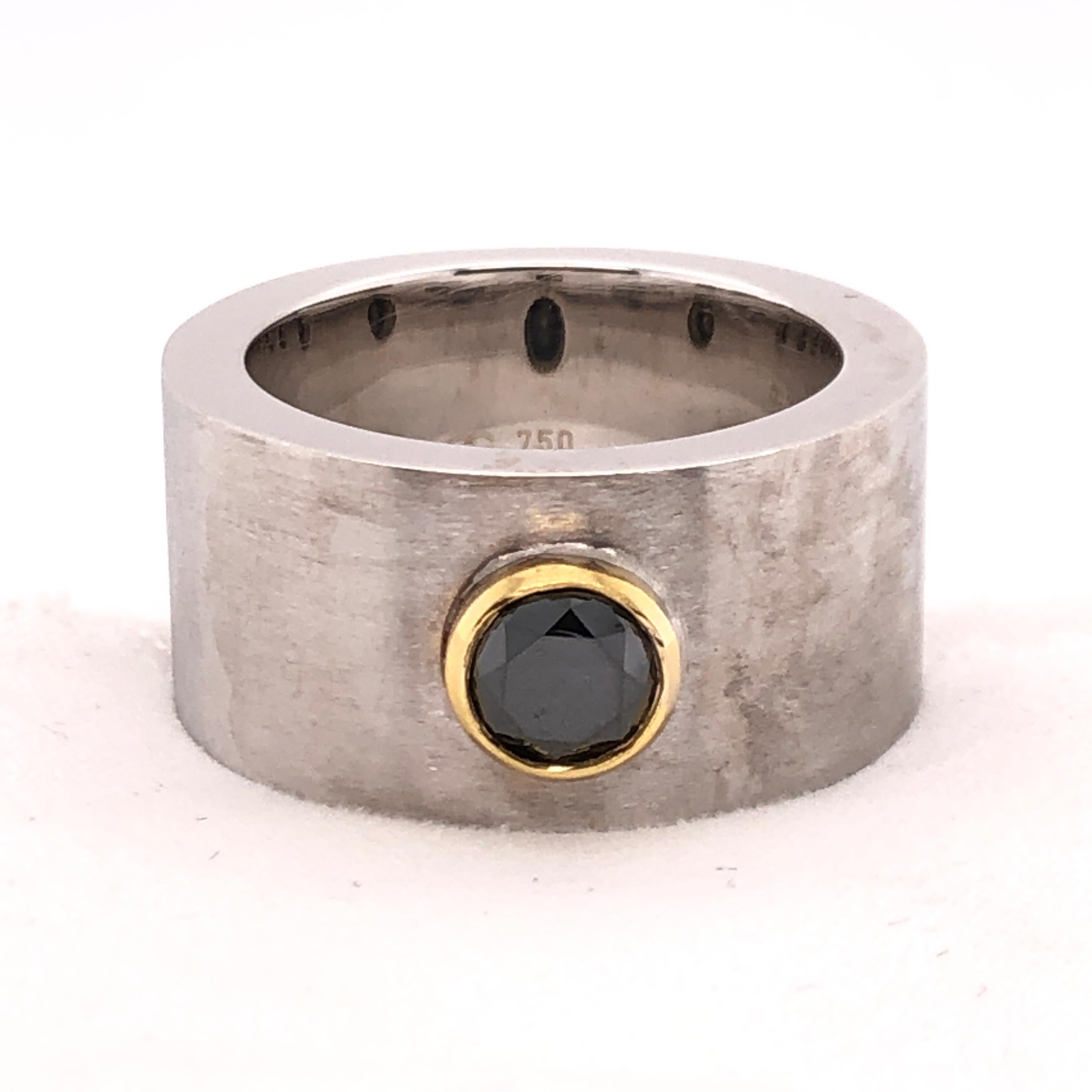 This is a substantial ring from Orianne Collins for a substantial character. A 1.02 CT round cut black diamond set into a yellow gold bezel creates the focal point against the stout brushed white gold band. 
Versatile and a conversation starter,