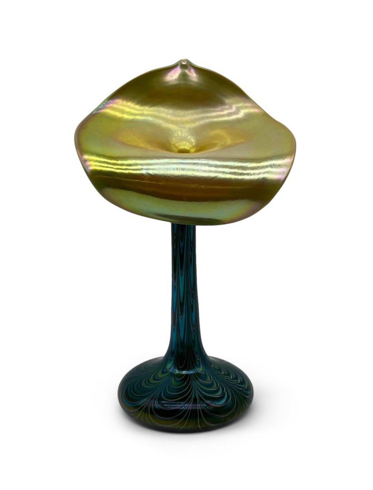 Outstanding iridescent pulled feather art glass Jack in the Pulpit vase by the renown glass artists at Orient & Flume. 
The front features a beautiful and vibrant iridescent gold. The base, neck and back  feature the intricate pulled feather method