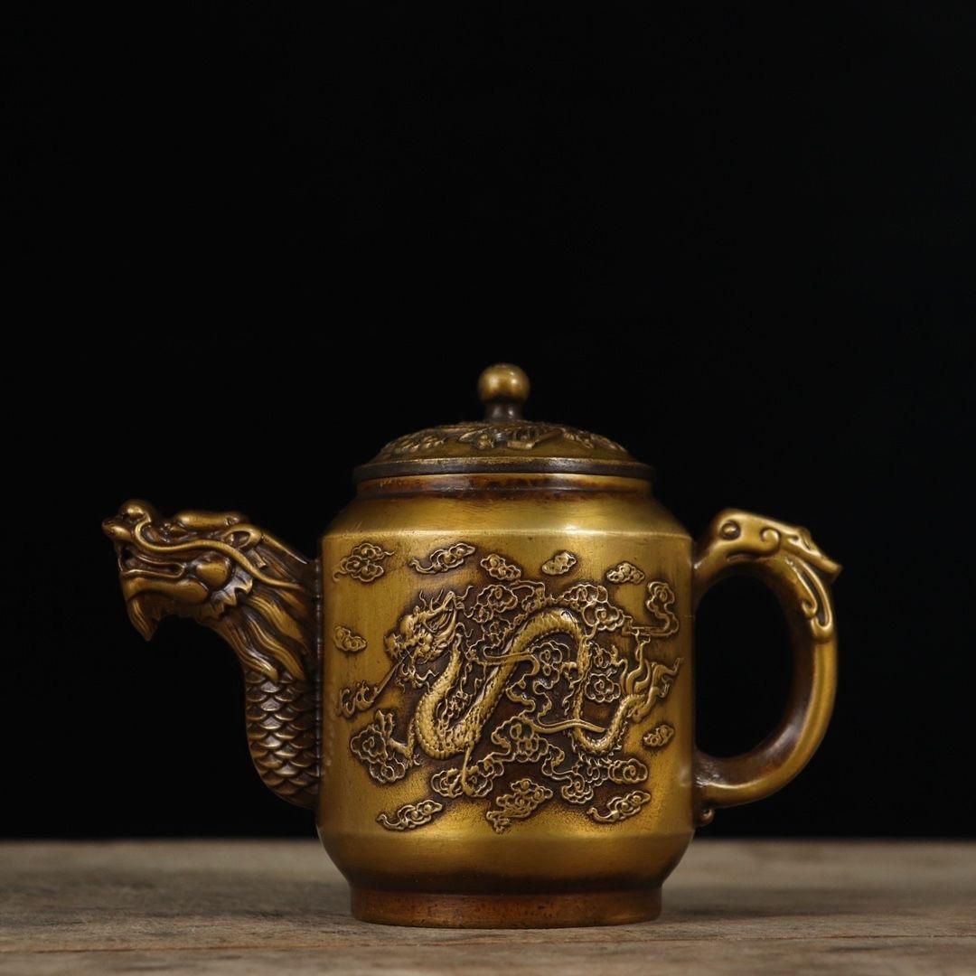 This Antique Chinese Bronze Teapot (which also could be used as Wine Pot) is  very beautiful and powerful, both sides are with Dragon Phoenix Decoration, also the pouring mouth is a dragon head, the handle is a special Chi Long.

Bronze dragon and