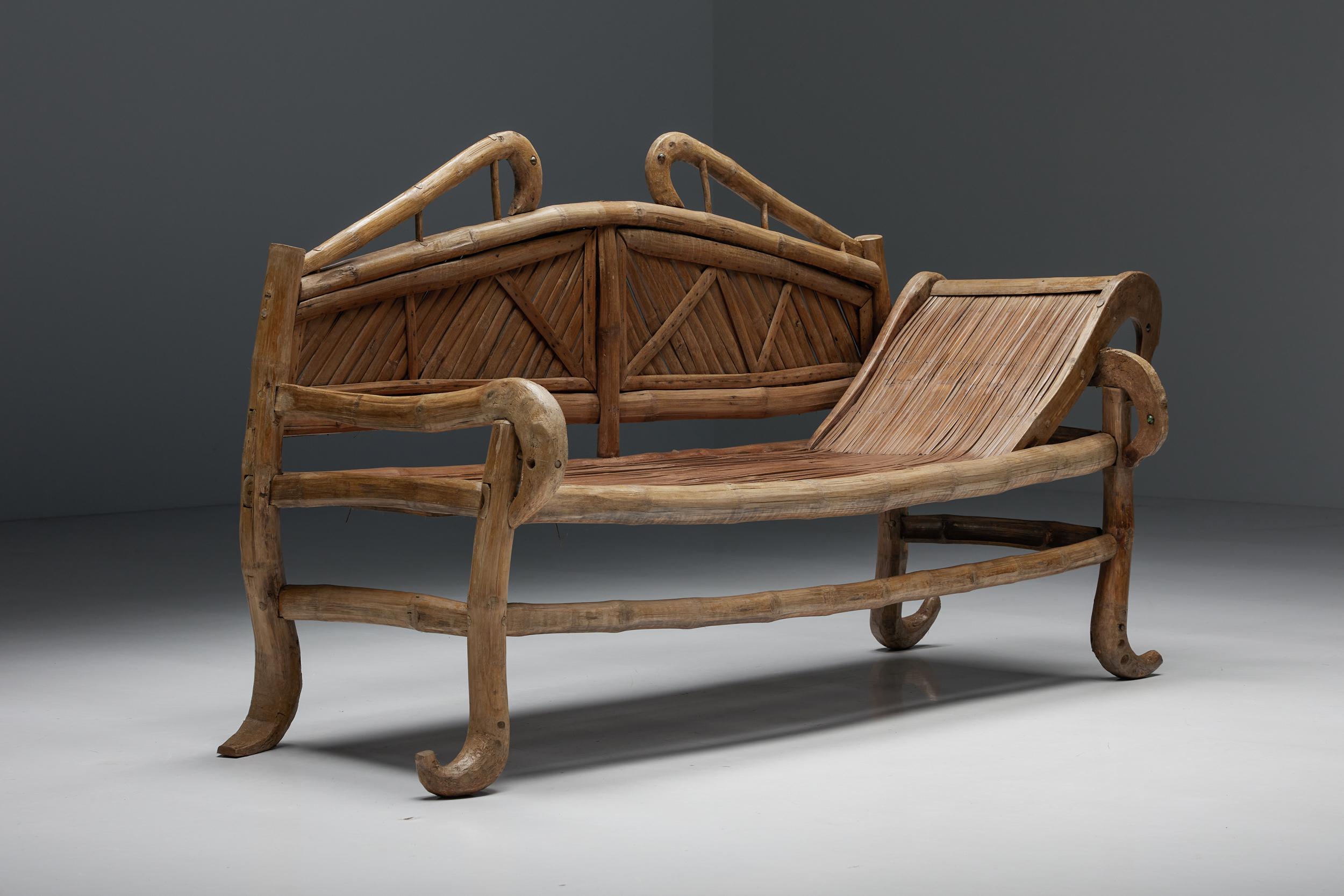 Oriental; bamboo; sofa-bed; daybed; 20th century; Bohemian; French; organic; curved; bench;

A 20th-century oriental daybed made of bamboo, raised on four organic legs ending in a curled foot and connected by three spacer bars. The backrest is