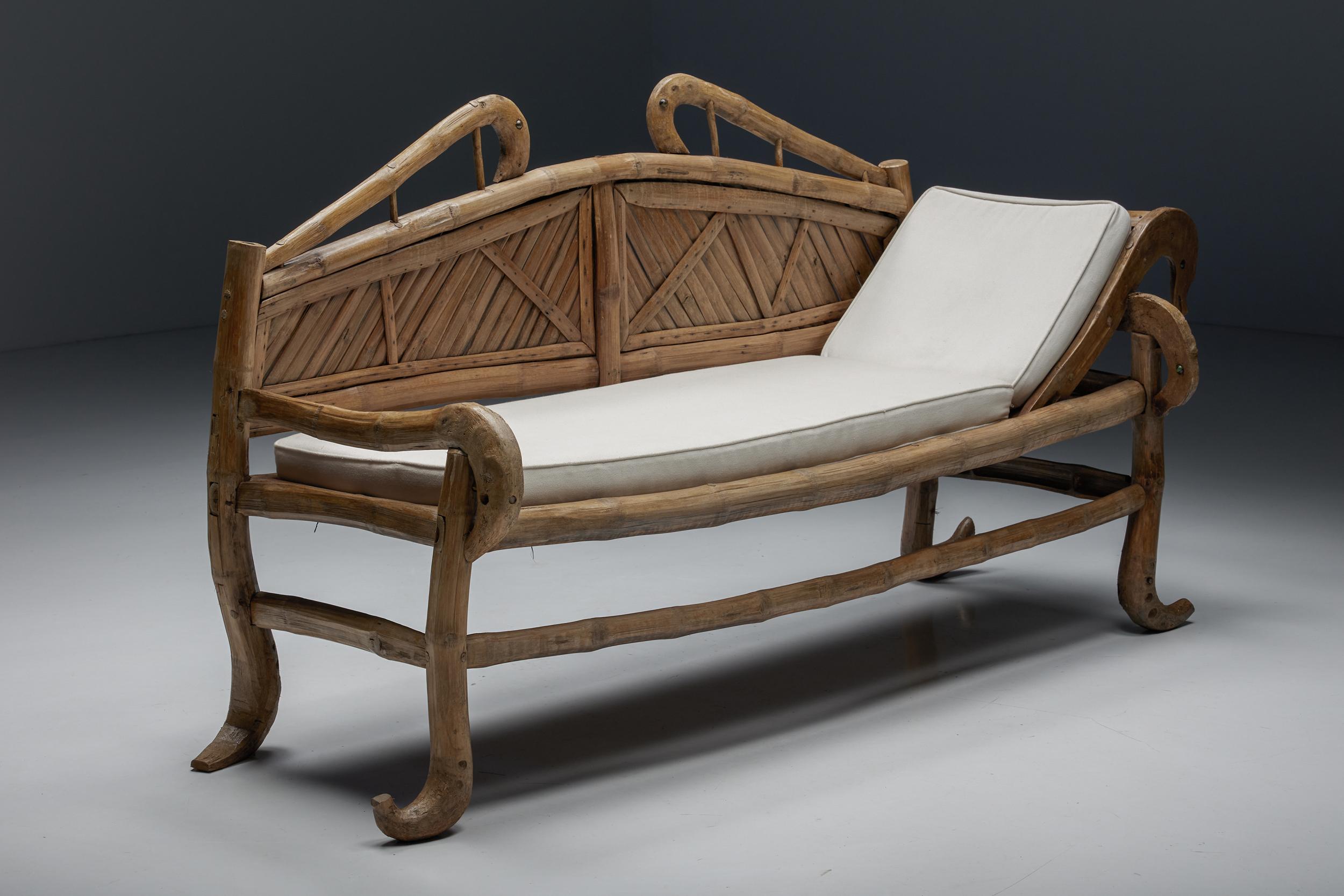 Oriental; bamboo; sofa-bed; daybed; 20th century; Bohemian; French; organic; curved; bench;

A 20th-century oriental daybed made of bamboo, raised on four organic legs ending in a curled foot and connected by three spacer bars. The backrest is also
