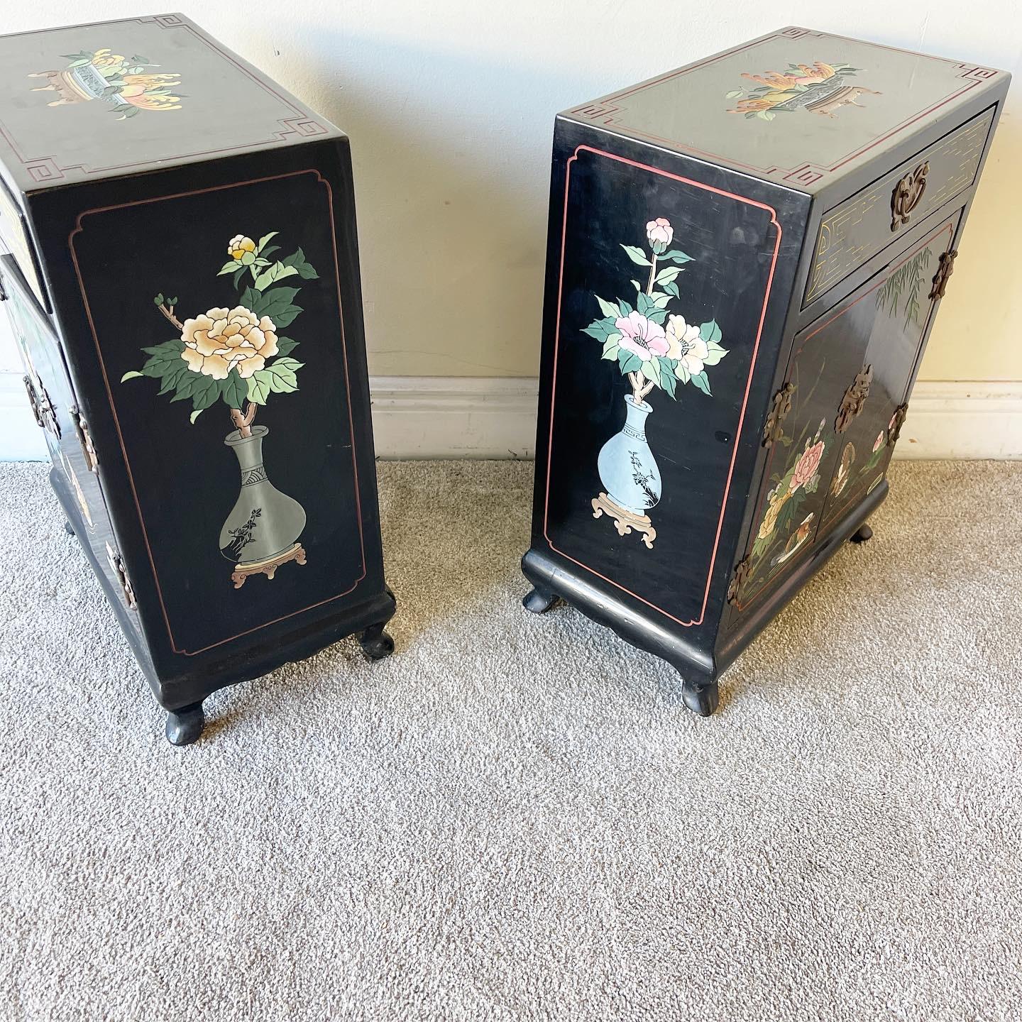 Incredible pair of Asian chinoiserie black lacquered shoe cabinets/side tables. Features hand painted and engraved floral and natural depictions.
 
