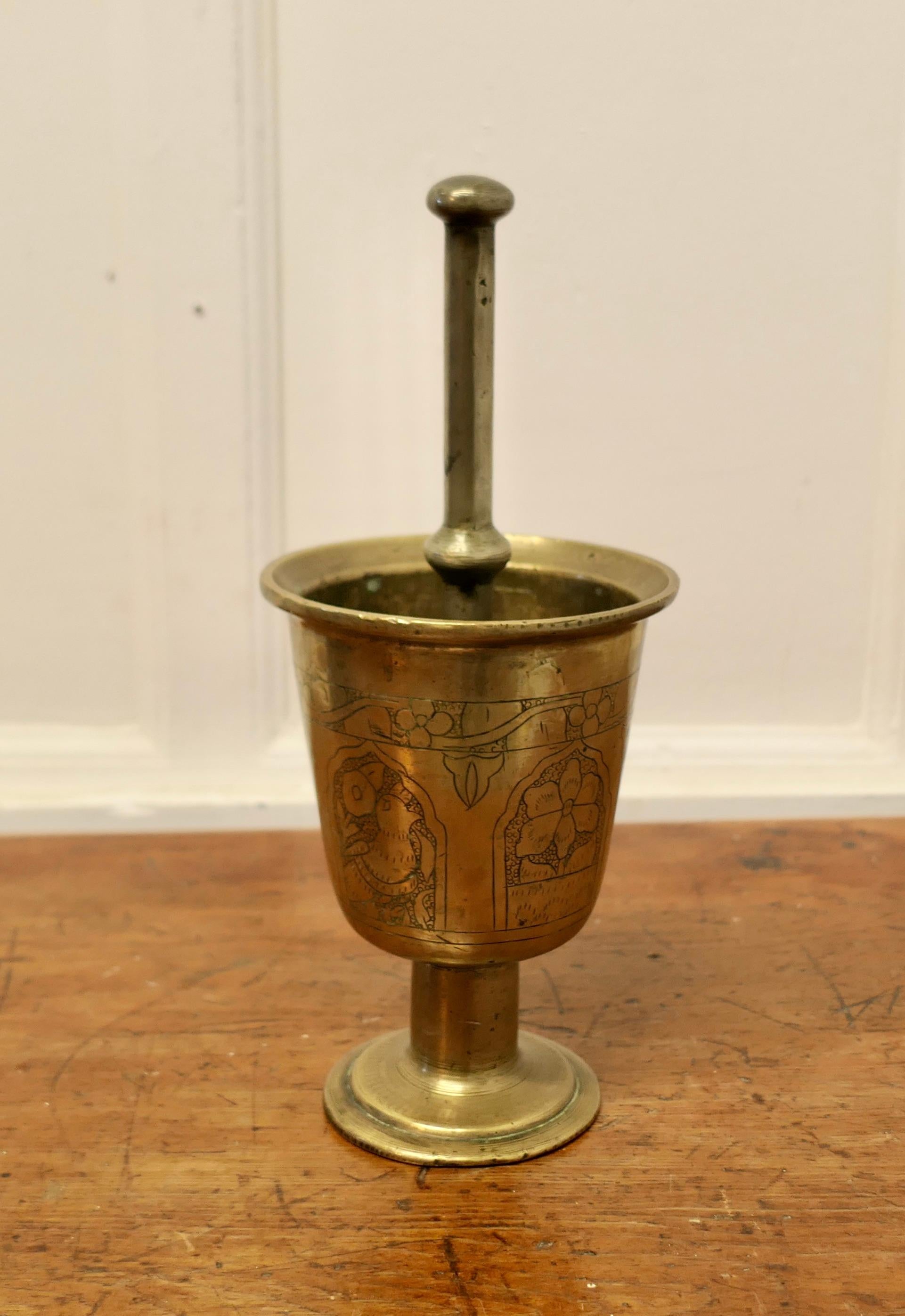 Oriental Brass Pestle and Mortar 

An unusual pair probably made for the preparation of herbal treatments The mortar is clean inside so it could be used in your kitchen, this is a very heavy pair, the Mortar is decorated with Flower and Birds
In