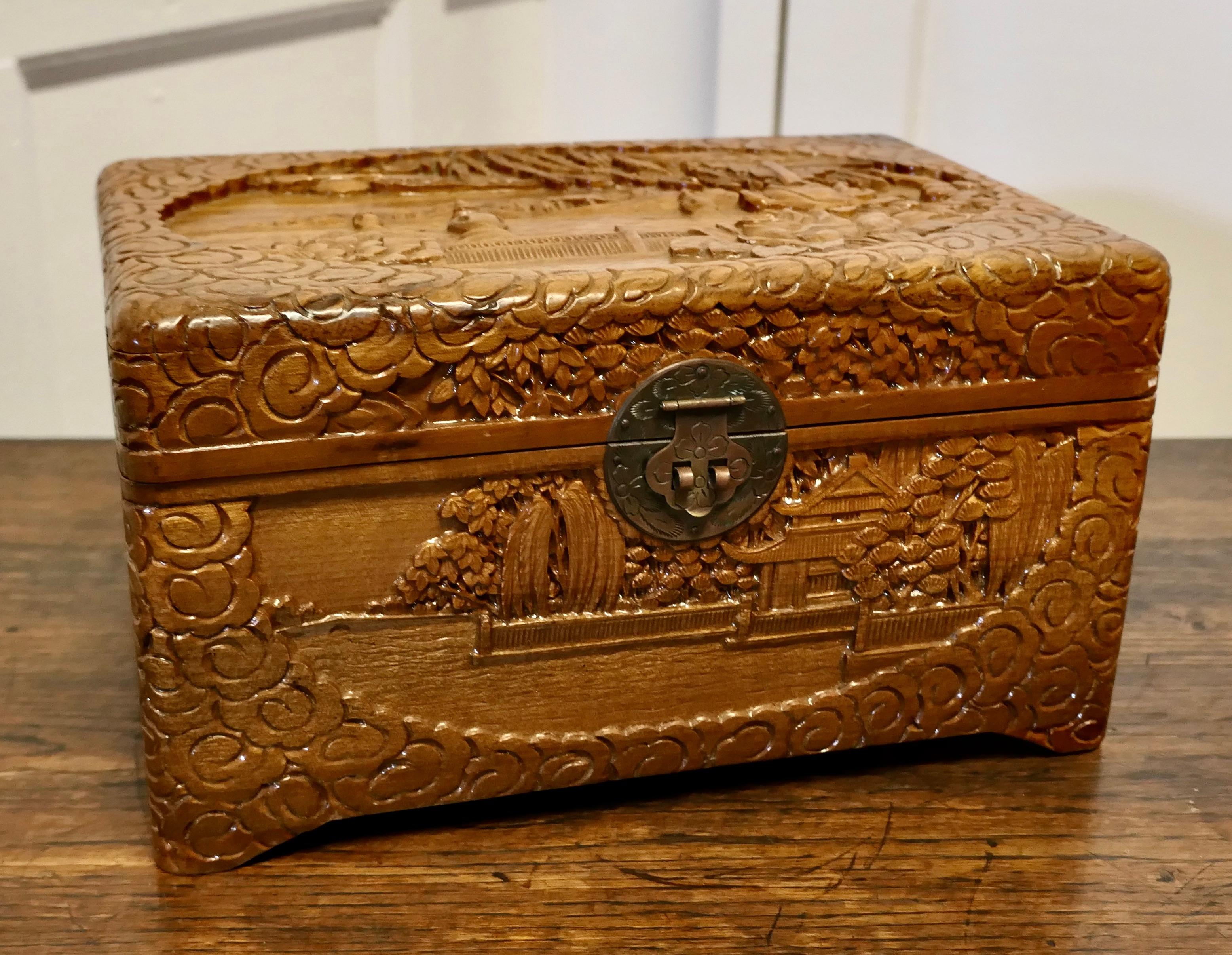Oriental carved camphor wood chest, jewellery casket.

This beautiful carved chest is made from camphor wood, for those of you who do not know camphor wood it is a hard wood which lends itself very well to carving and it has an excellent