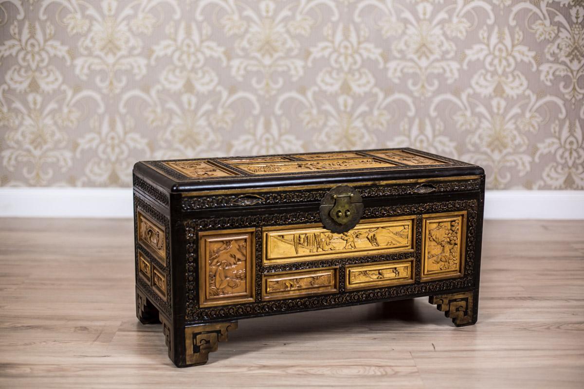 We present you this Chinese chest of a medium size, circa 1970s, made of exotic type of wood.
The outer surface is divided by ornamental lines into smaller sections, which are covered with a convex ornament with Chinese genre scenes.

Presented