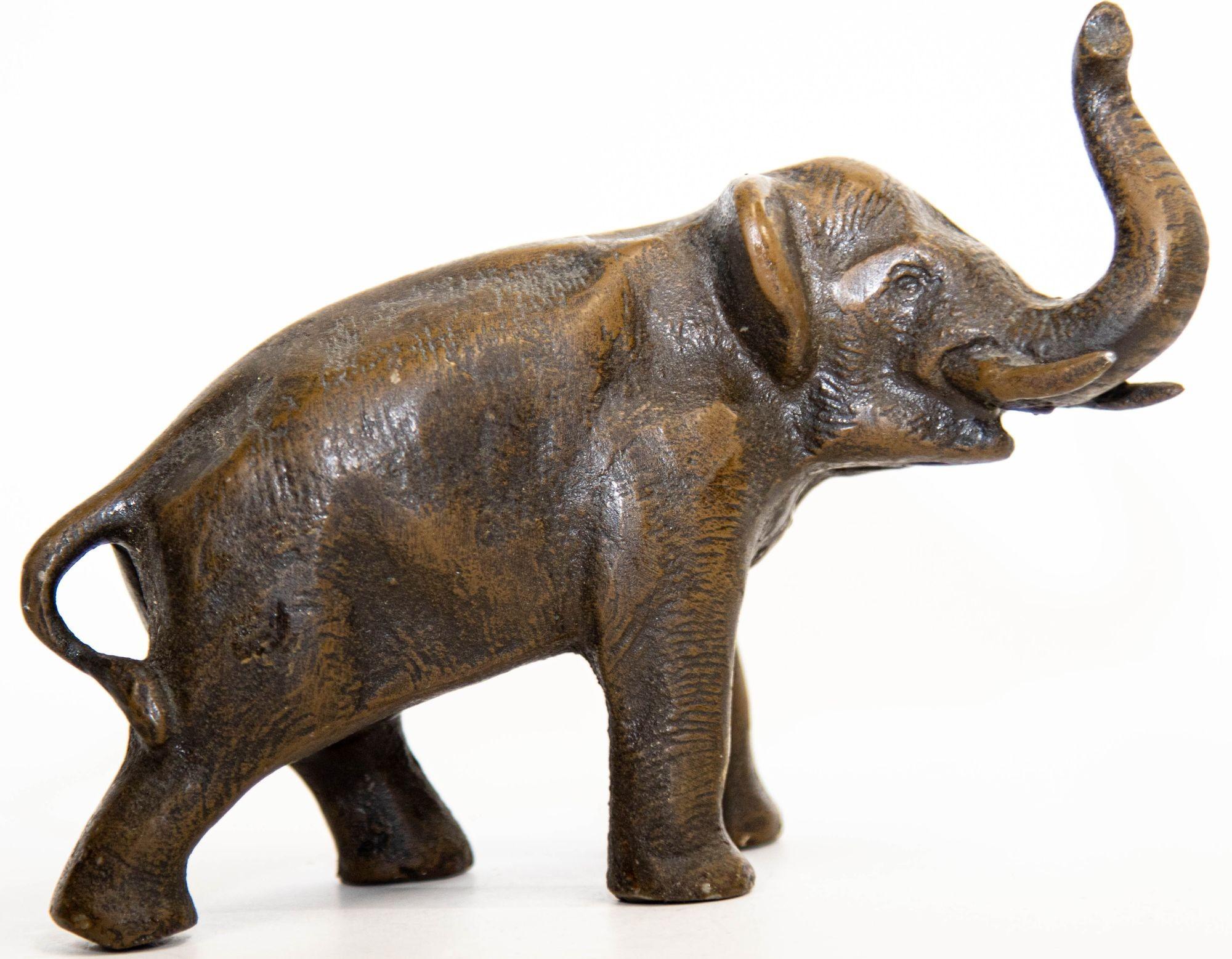 Beautiful Oriental Japanese Meiji period style bronze sculpture of a walking elephant with his trunk up.
Well casted metal art, heavy, bronze elephant in a dark brown copper finish.
Elephant figurine statue in a triumphant pose, will make an