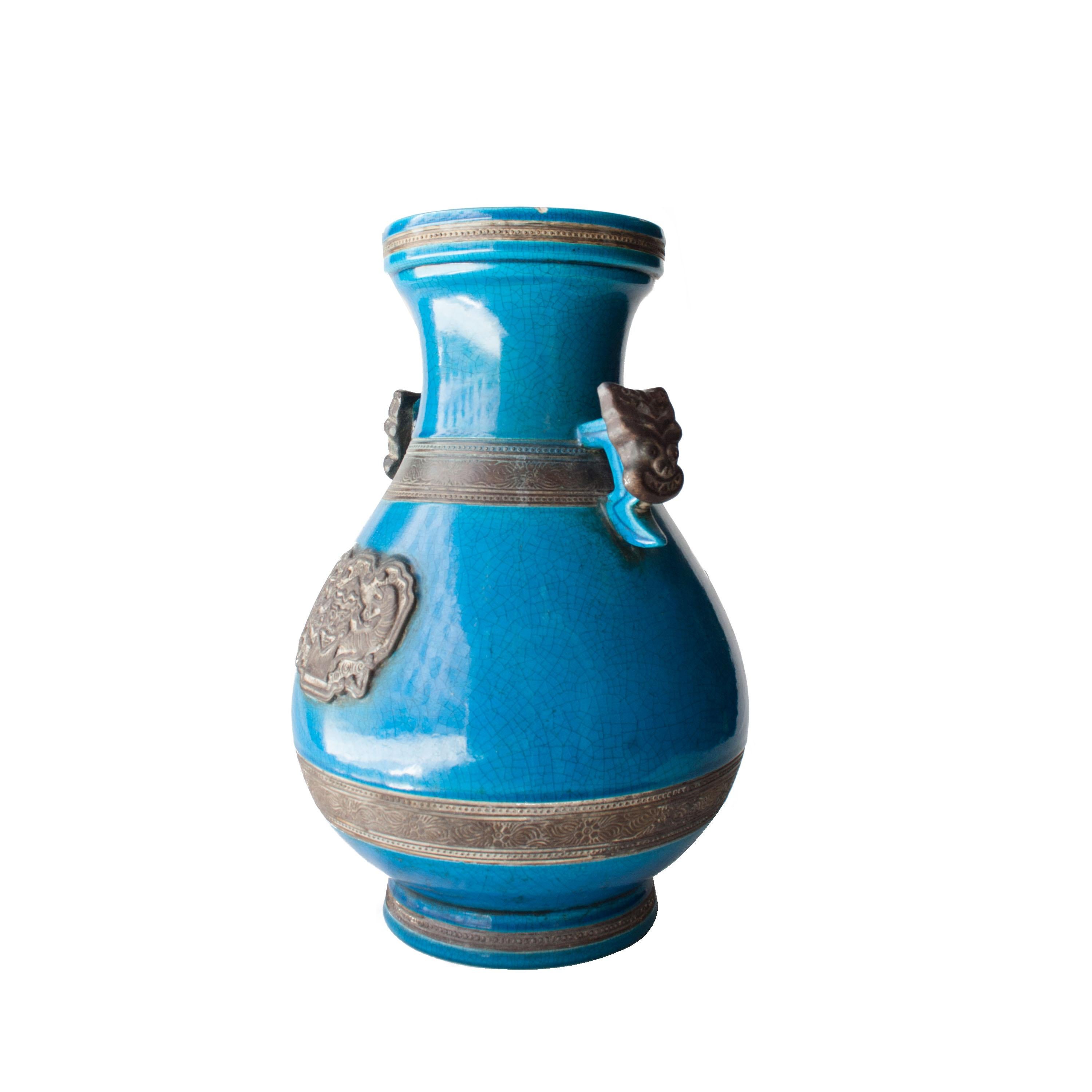 Turquoise ceramic vase with oriental motifs.
 