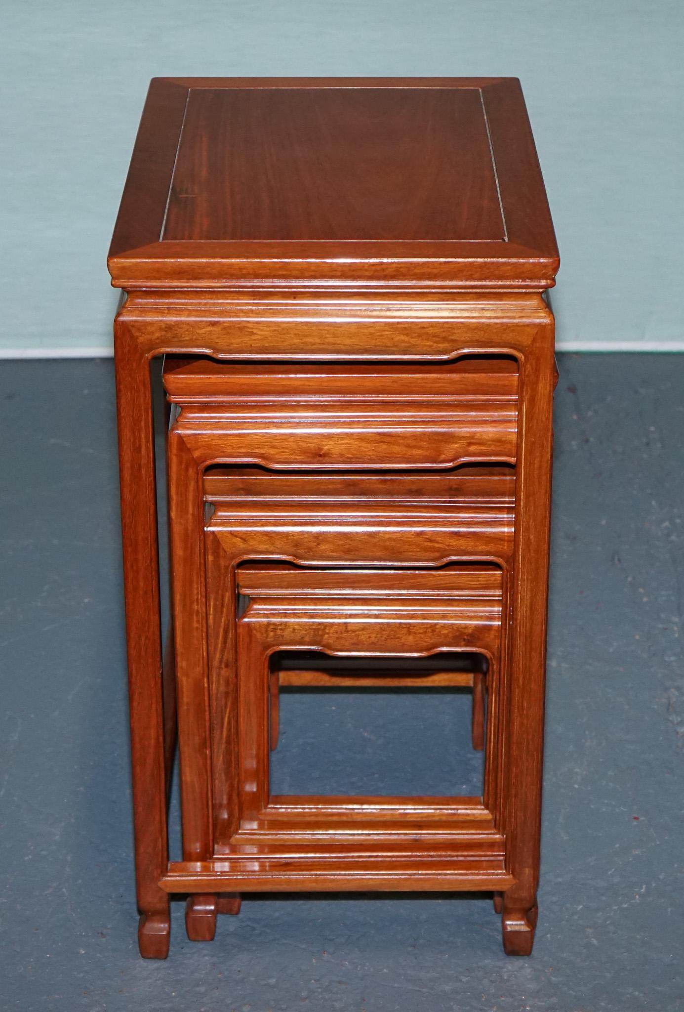 Chinese ORIENTAL CHINESE TEAK NEST OF FOUR TABLES WITH CARVED DETAiLS For Sale