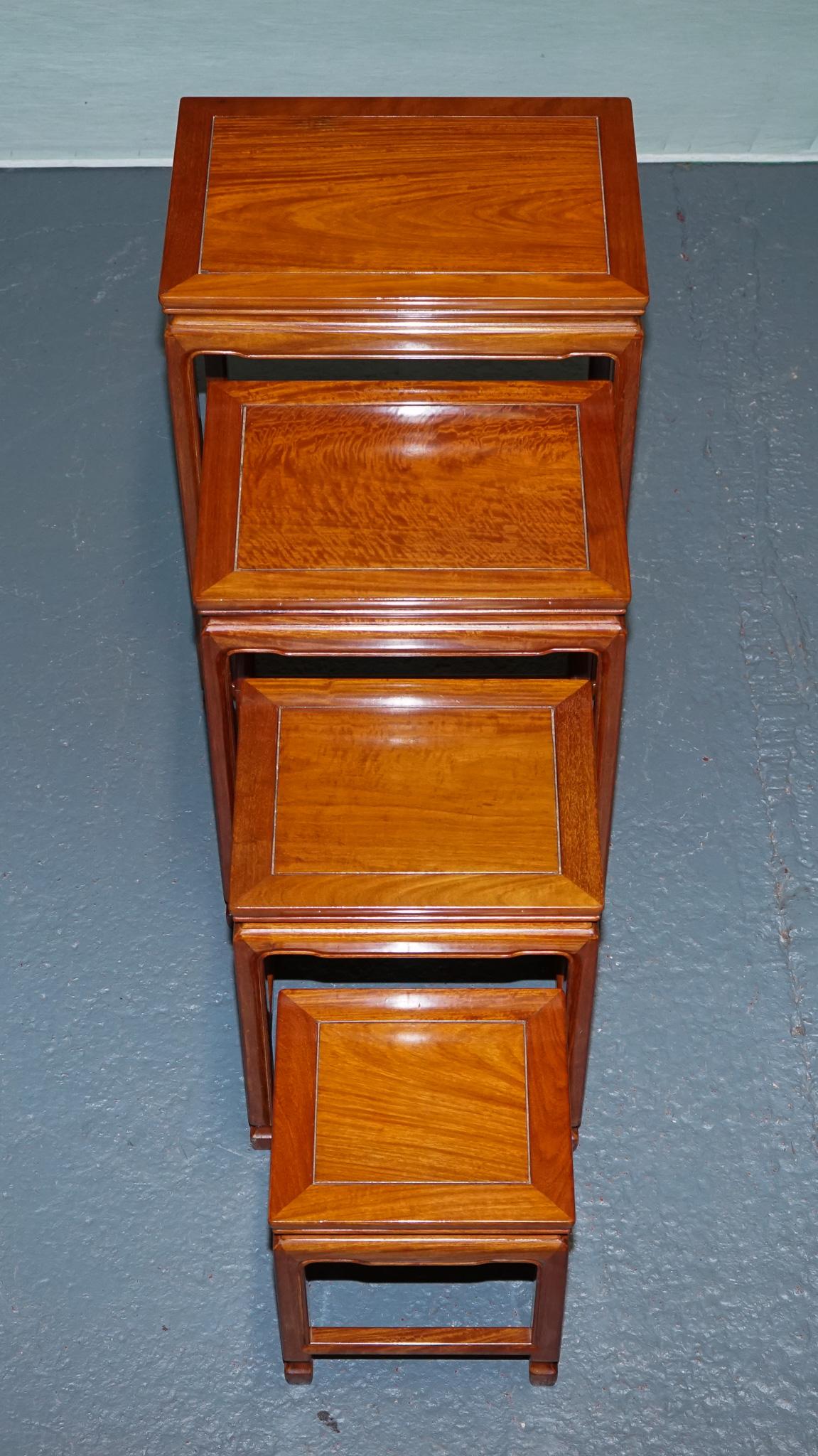 Teak ORIENTAL CHINESE TEAK NEST OF FOUR TABLES WITH CARVED DETAiLS For Sale