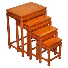 ORIENTAL CHINESE TEAK NEST OF FOUR TABLES WITH CARVED DETAiLS
