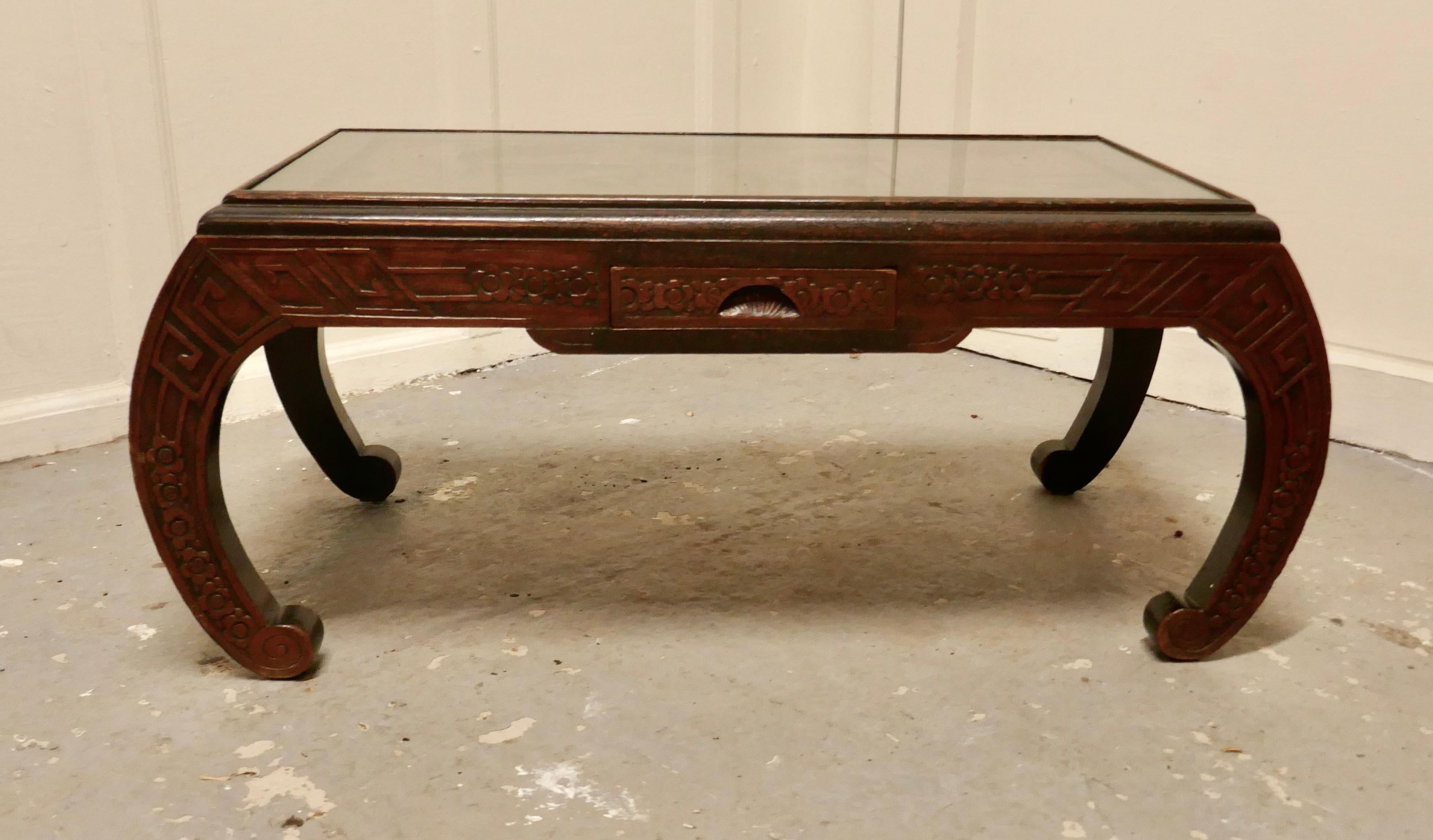 Oriental deeply carved low table, coffee table

This is a very attractive piece, the table is in the style of an opium table, it has a two tone lacquer finish accentuating the detail of the carving
The table top has superb patina and an inset