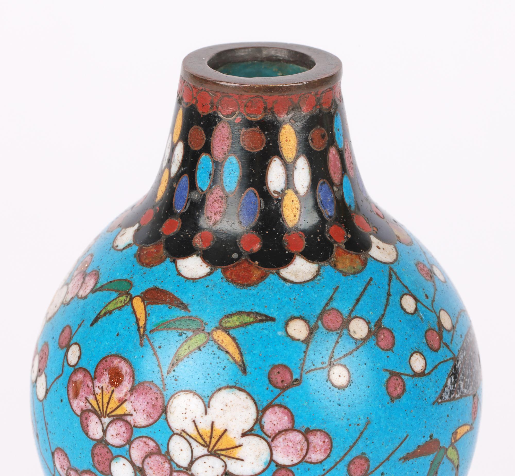 A very fine and stylish antique oriental, Chinese attributed, cloisonne double gourd vase dating from the latter 19th century. The vase stands on a flat brass base with a wide round base, pinched waist and narrow round upper section with a funnel