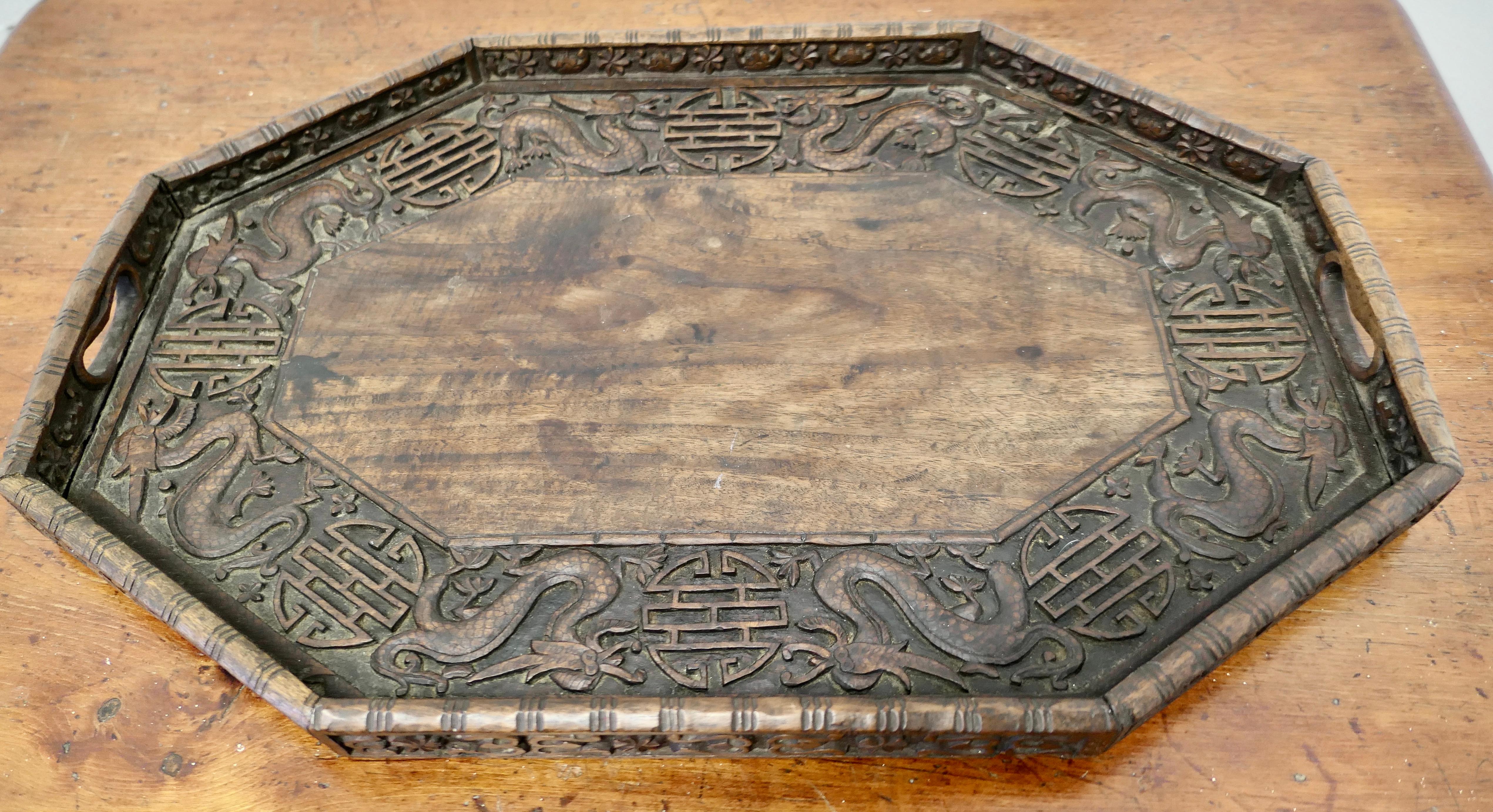 Oriental Folk Art Carved Dragon Tray

This is a lovely piece of hand carving, the tray is octagonal with a dragon at every corner 
A superb piece which neat handles carved into the gallery
The tray is 2” high, and is 24” x 16” 
MS183.