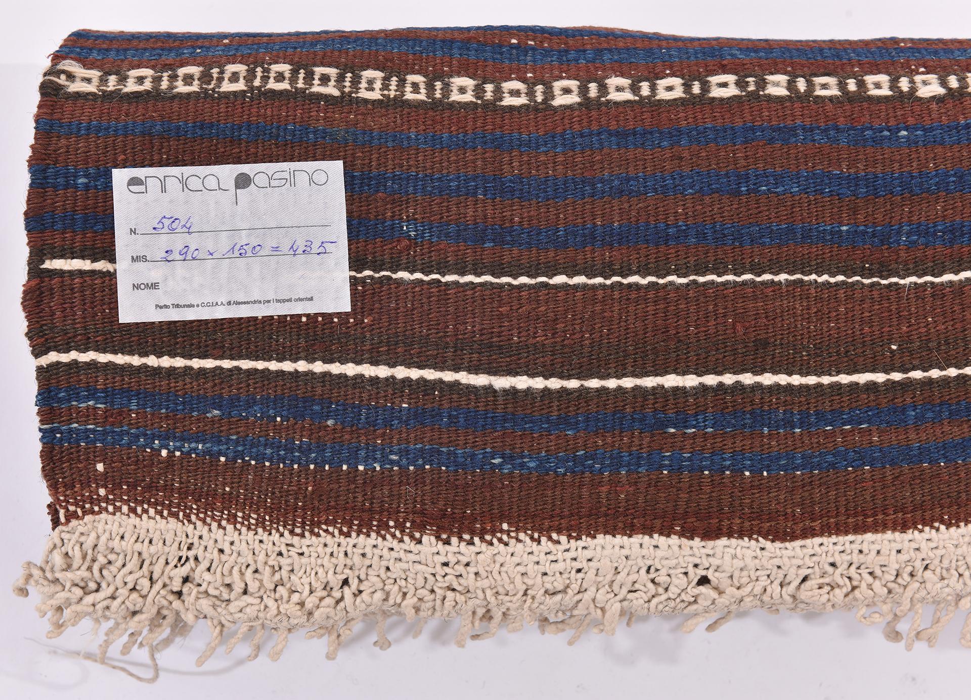 nr. 504 - Another example from my collection of nomadic kilims, now on sale for closing activities.
Thin blue and white lines on a brown background; sober and almost severe, but softened by white embroidered stripes.  Very particular.  Excellent