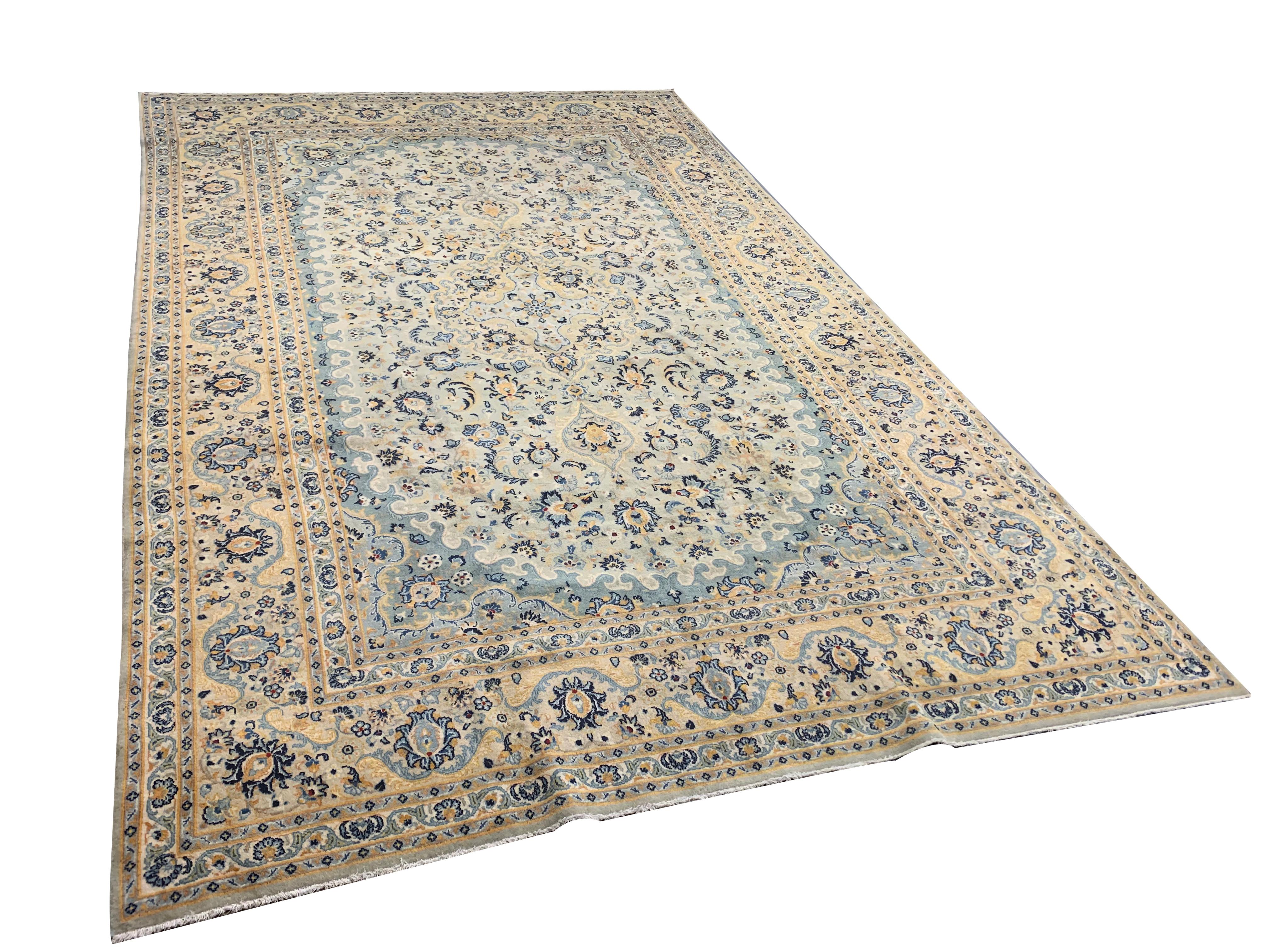 Subtle cream, blue, yellow and beige accents make up the colour palette of this beautiful wool area rug. Woven with a bold floral all-over pattern, intricately woven with fine floral details through both the centre and enclosing border. The