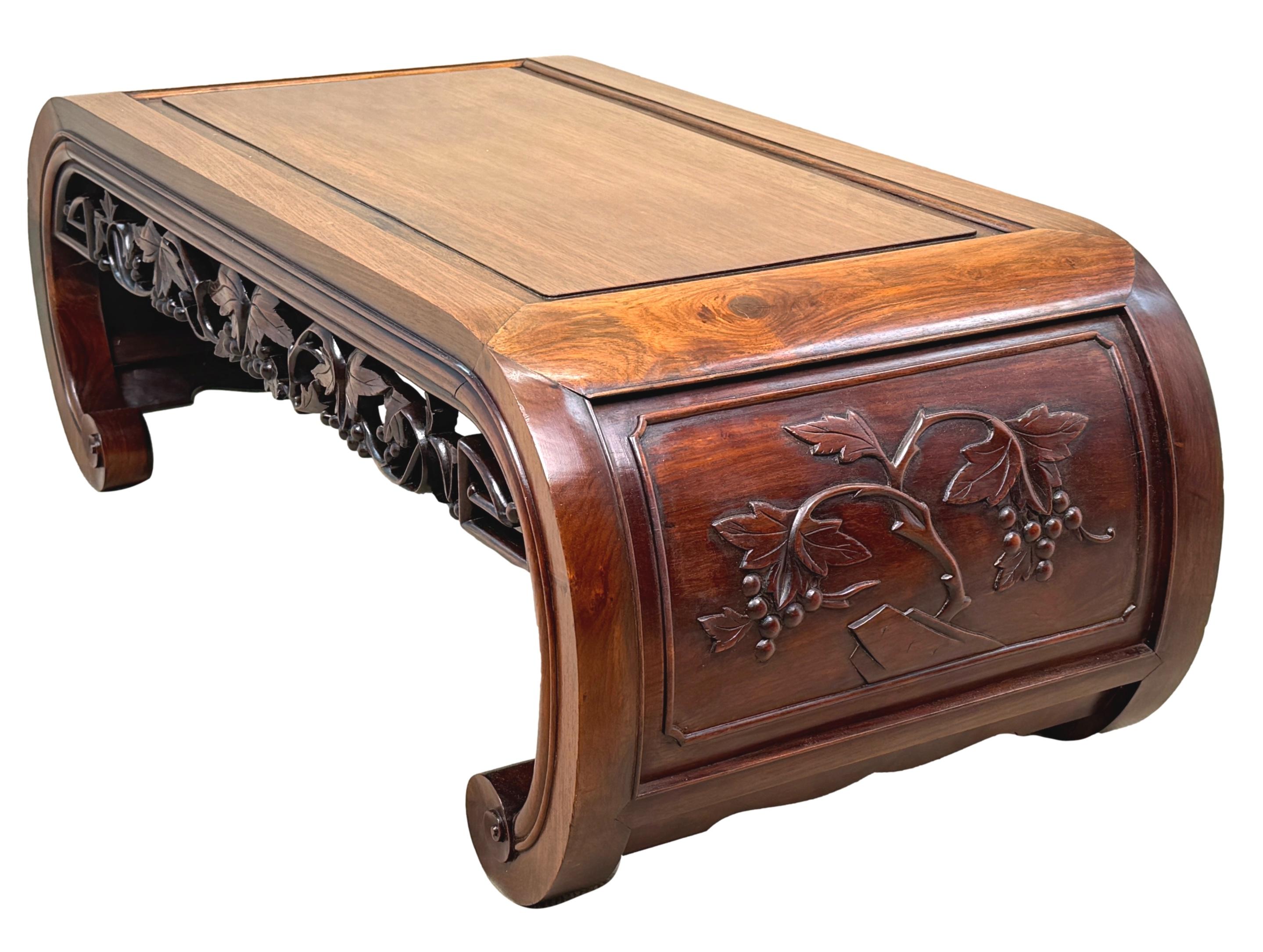 An Extremely Good Quality Late 19th Century Oriental Hardwood Coffee Table, Or Opium Table, Having Very Well Figured Panelled Top, Over Elegantly Carved And Pierced Frieze, Flanked By Attractive Solid Curved Ends With Further Carved Decoration And